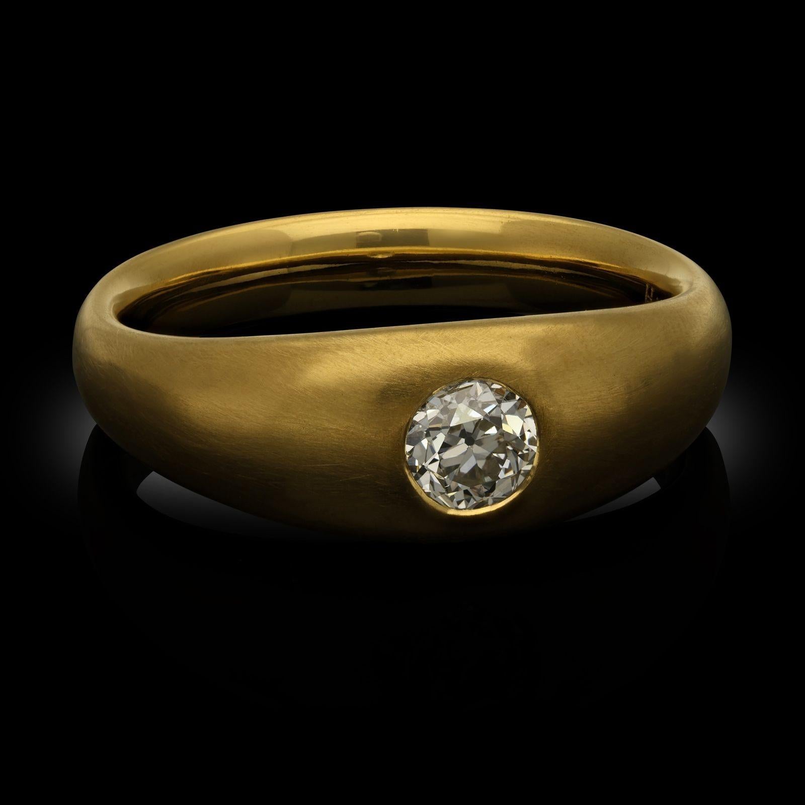 An old cut diamond and yellow gold band set ring by Hancocks. The ring is set in the centre with an old European cut diamond weighing 0.54ct set flush in a gypsy-style setting within a handcrafted 22ct yellow gold band with a brushed satin finish