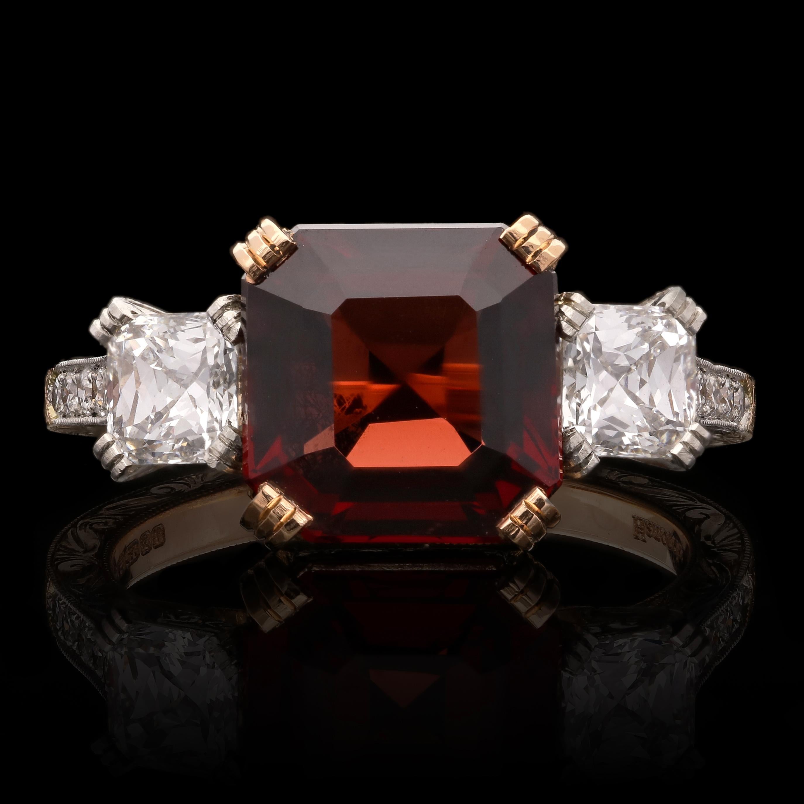A beautiful spinel and diamond three stone ring by Hancocks, set to the centre with an Asscher cut Burmese red spinel weighing 4.09cts in an 18ct rose gold corner claw setting, between two Asscher cut diamonds weighing 0.91ct in total set in