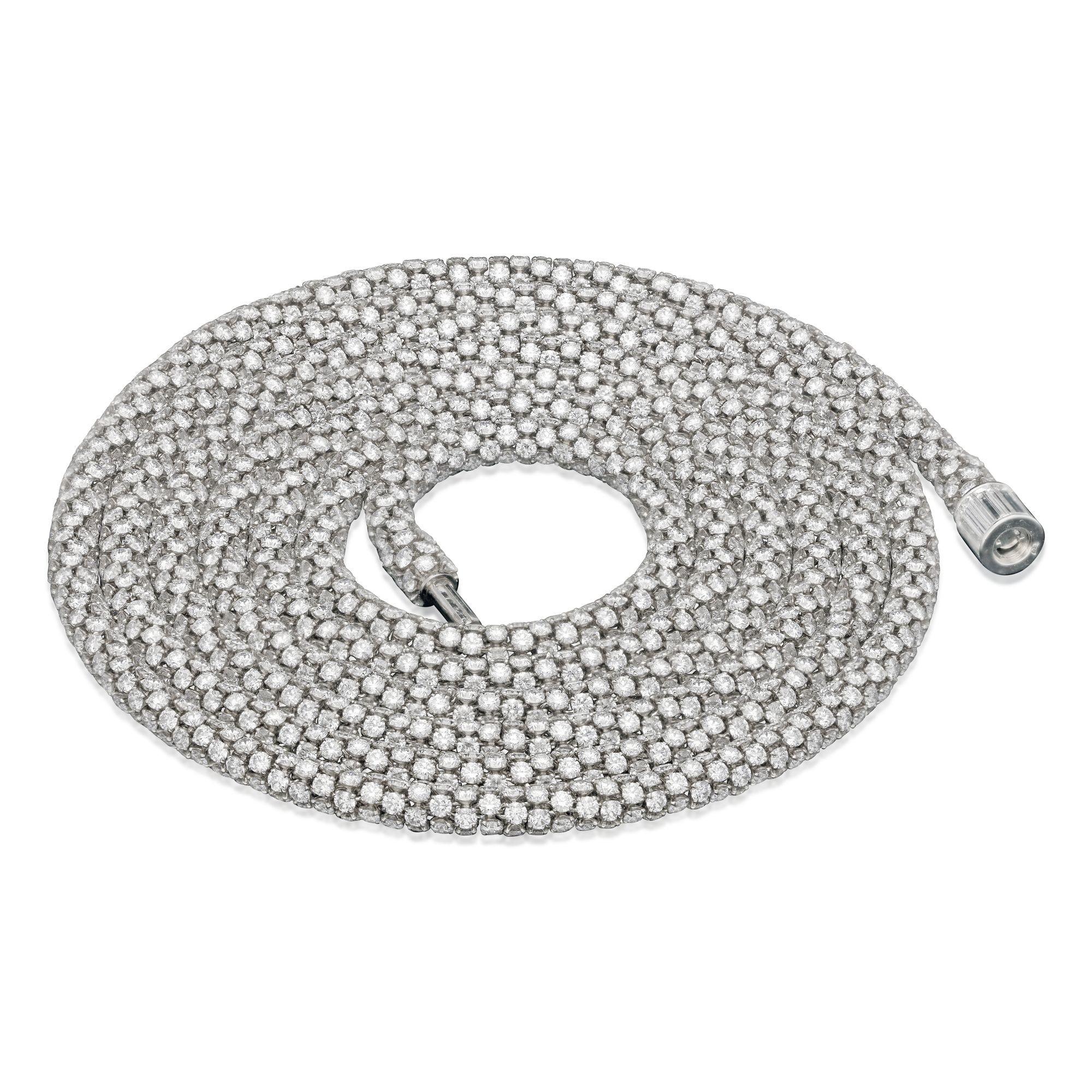 A beautiful diamond and platinum necklace by Hancocks, the highly articulated and wonderfully flexible necklace formed of many uniform rondelle shaped links each set in the round with five round brilliant cut diamonds and each rondelle each closely
