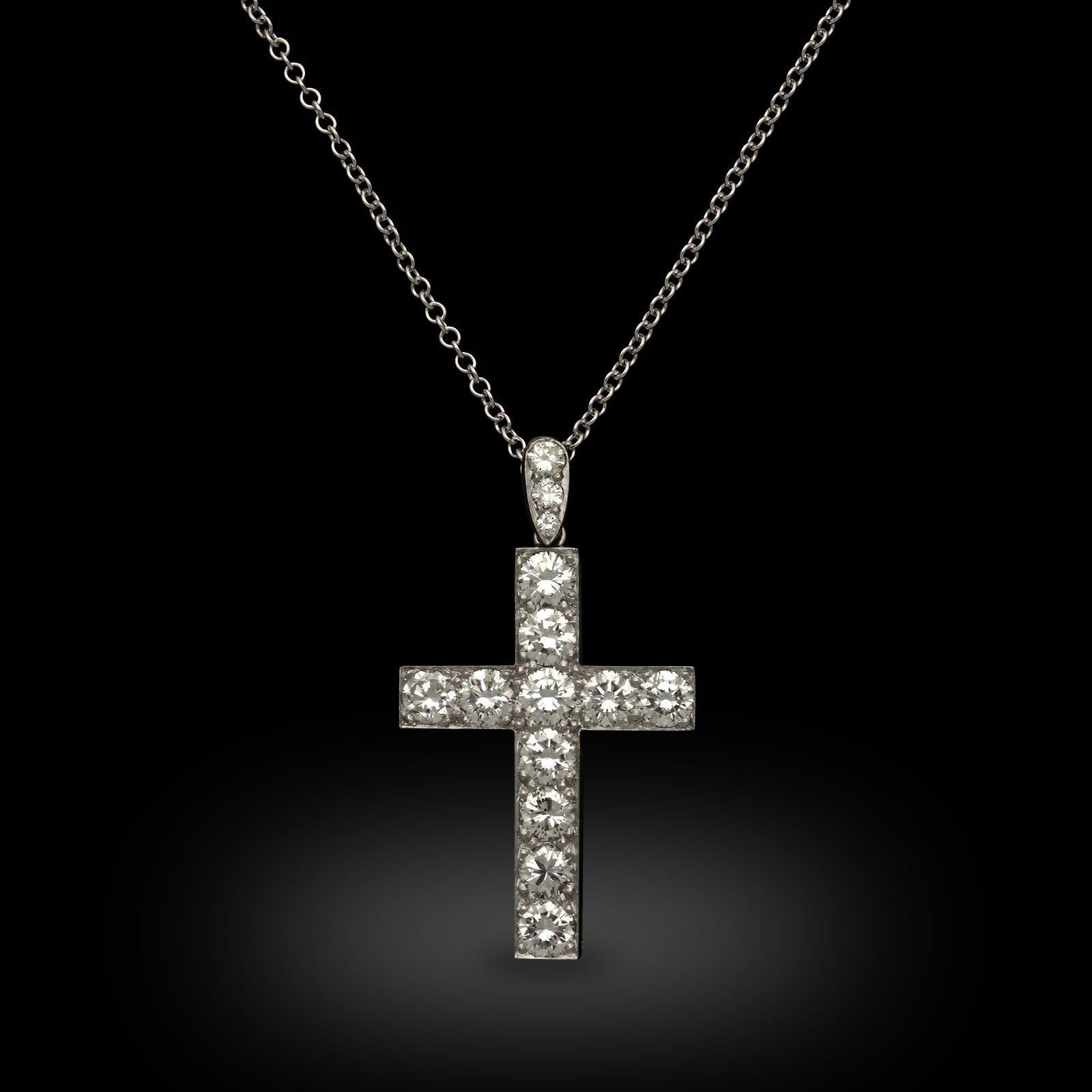 Maker:
Hancocks
Summary:
Diamond & Platinum Cross Pendant
Description:
A diamond cross pendant, circa 1990. This Latin style cross is crafted in platinum and set with eleven round brilliant cut diamonds, suspended from a diamond set pear shape