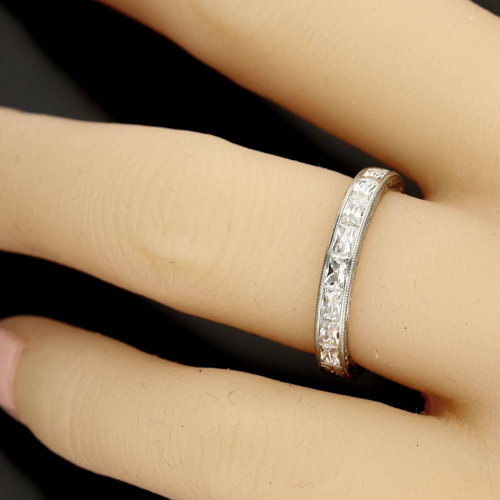 The ring is 3/4 set with rectangular French cut diamonds, channel set in decoratively hand-engraved platinum.
15x rectangular French cut diamonds of G colour and VS clarity with a combined weight of 1.18cts.
UK finger size L1/2 (resizeable). Or