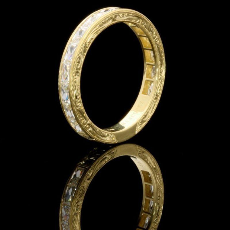 A beautiful French-cut diamond and yellow gold eternity ring by Hancocks, the ring three quarter set with beautiful rectangular French cut diamonds weighing a total of 1.10cts and of G colour and VS clarity set horizontally within a finely crafted