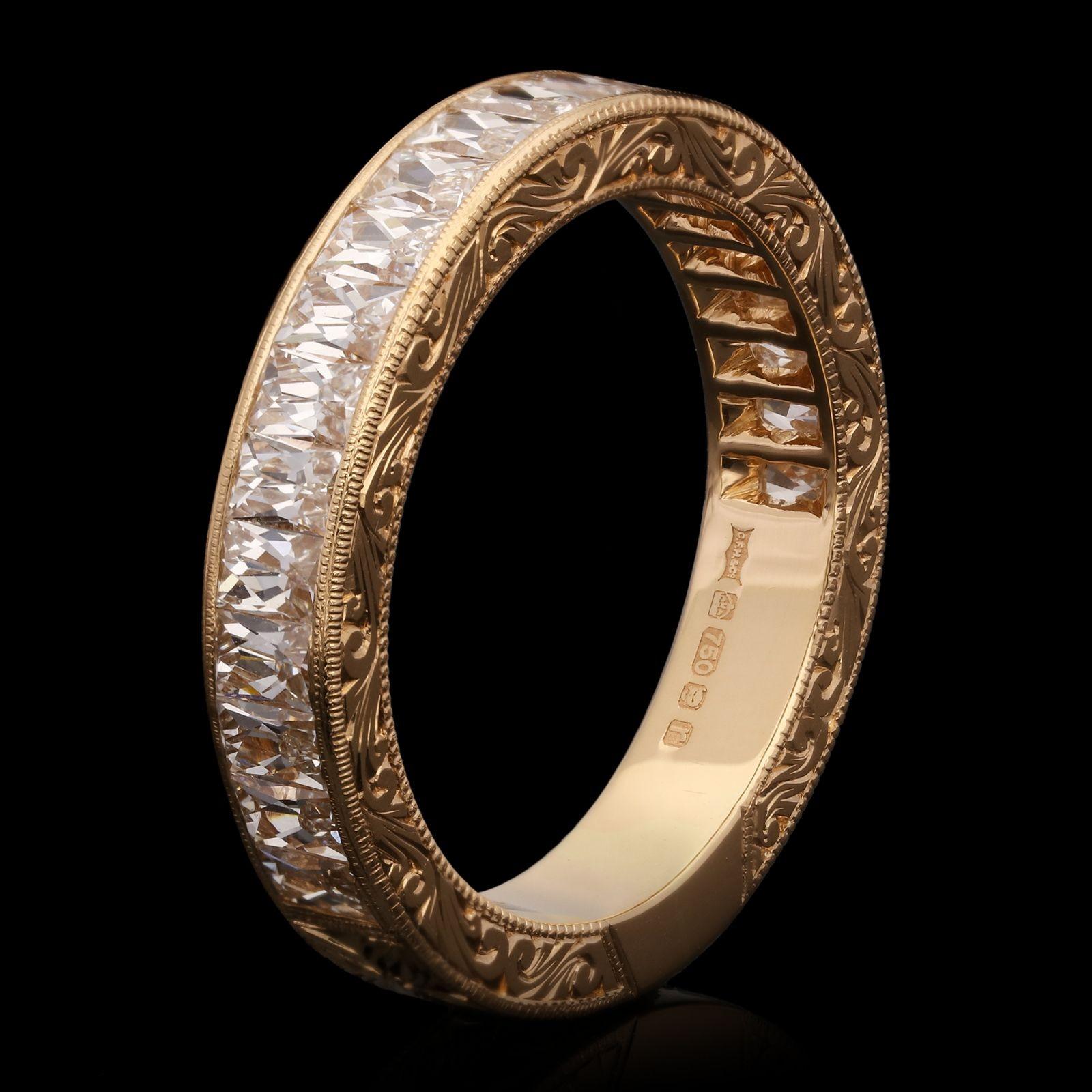 A stunning French-cut diamond and rose gold eternity ring by Hancocks, the ring three quarter set with beautiful rectangular French cut diamonds weighing a total of 1.50cts and of G colour and VS clarity set vertically within a finely crafted and