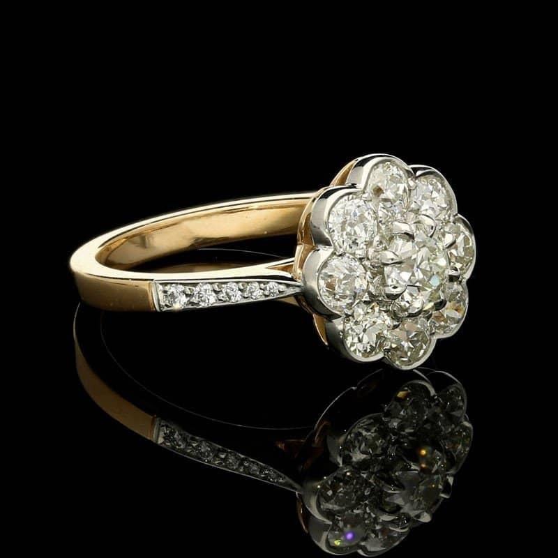 A classic old cut diamond cluster ring by Hancocks, centred with an old European brilliant cut diamond weighing 0.41cts and of K colour and VS1 clarity claw set within a cluster surround of eight old European brilliant cut diamonds in rubover