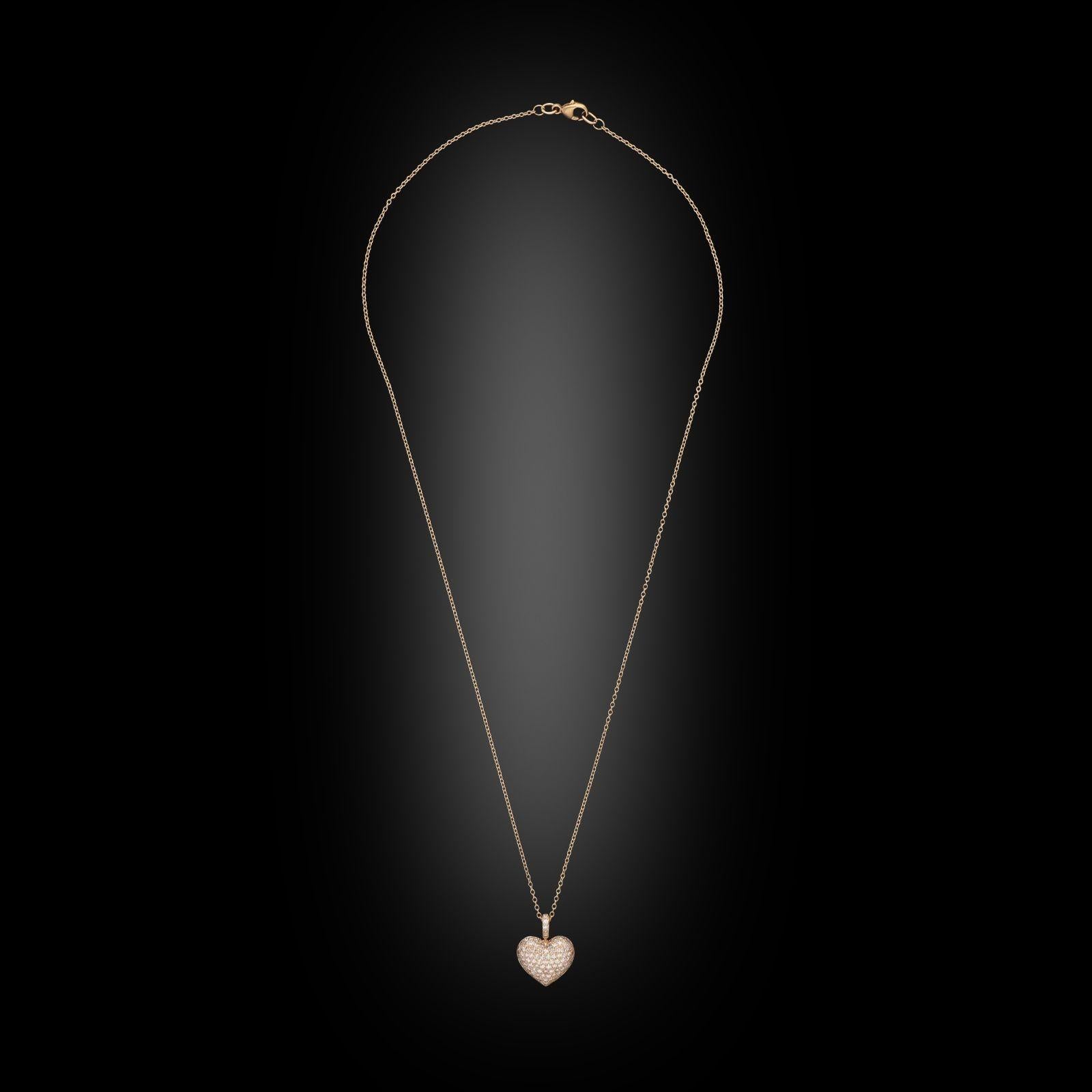 A pink diamond and rose gold heart shaped pendant by Hancocks, the heart with domed profile pavé set across the front with single cut pink diamonds in 18ct rose gold, suspended from a diamond set bale, hung from an 18” rose gold trace chain. This