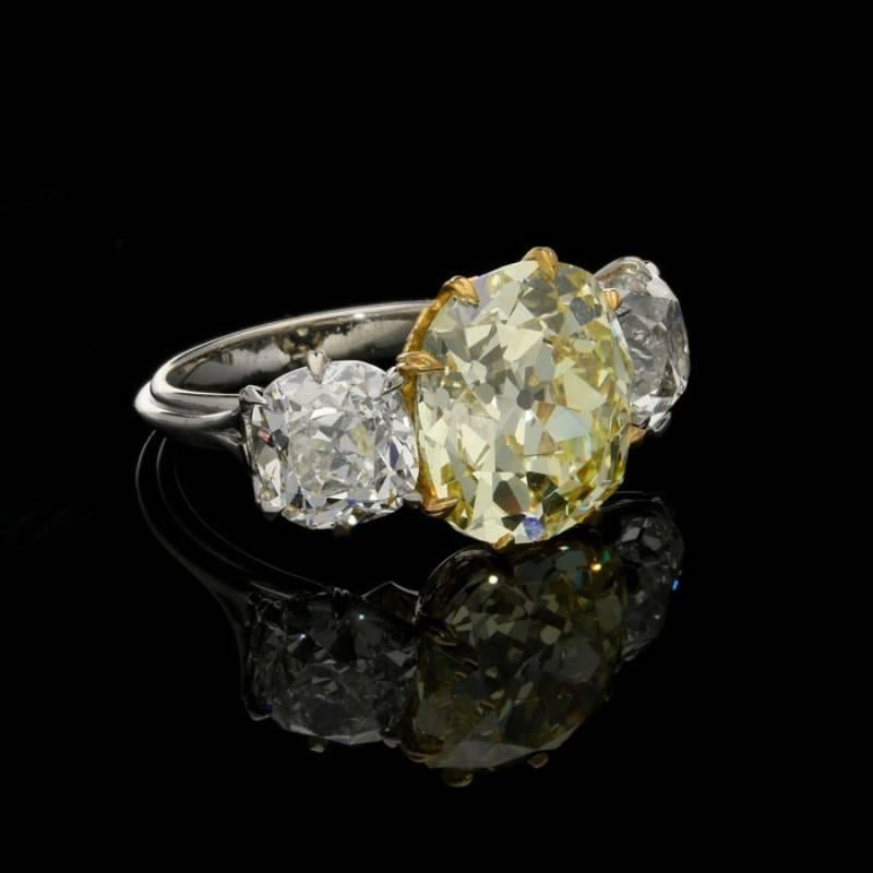 Contemporary Hancocks Three-Stone Diamond and Fancy Intense Yellow Diamond Ring