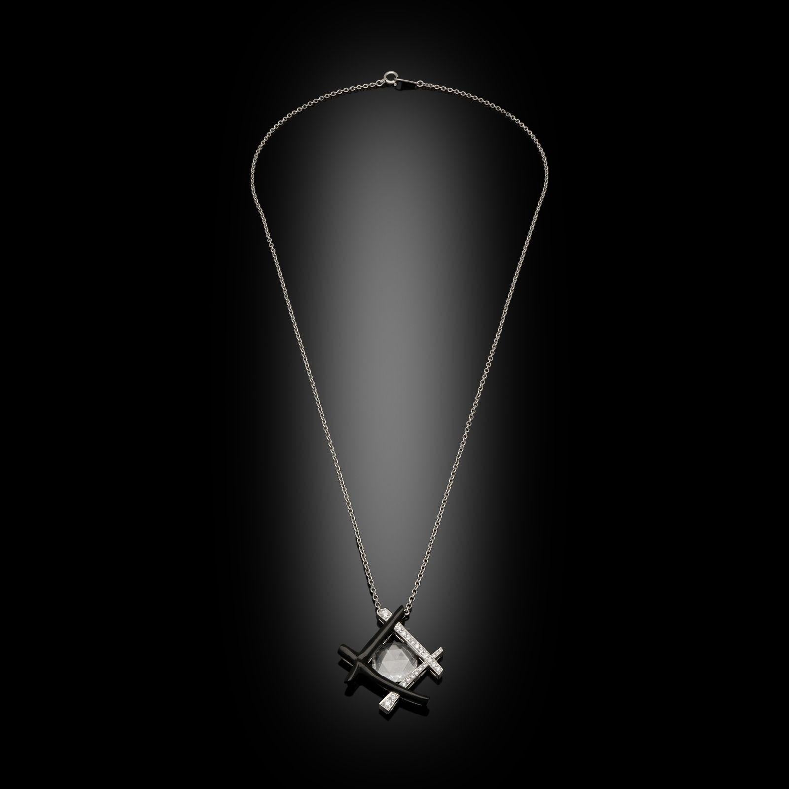 An unusual rose cut diamond pendant by Hancocks, set to the centre with a beautiful, high quality rose cut diamond weighing 1.12cts and of D colour and VVS2 clarity within an abstract geometric frame inspired by oriental bamboo motifs, two of the
