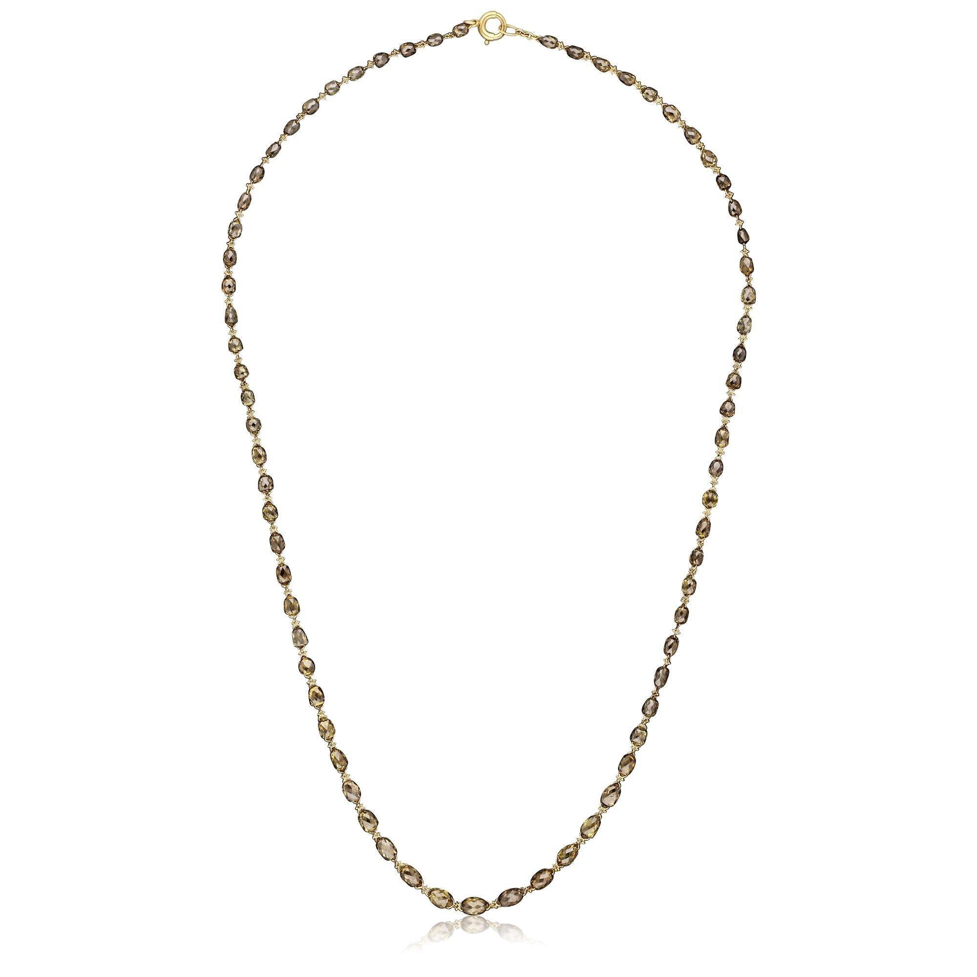 A beautiful briolette diamond and gold necklace by Hancocks, the 16″ chain formed of seventy vintage-cut oval briolette diamonds weighing 15.56cts in total and with a lovely subtle range of colours from greenish-yellow to smoky light brown, joined