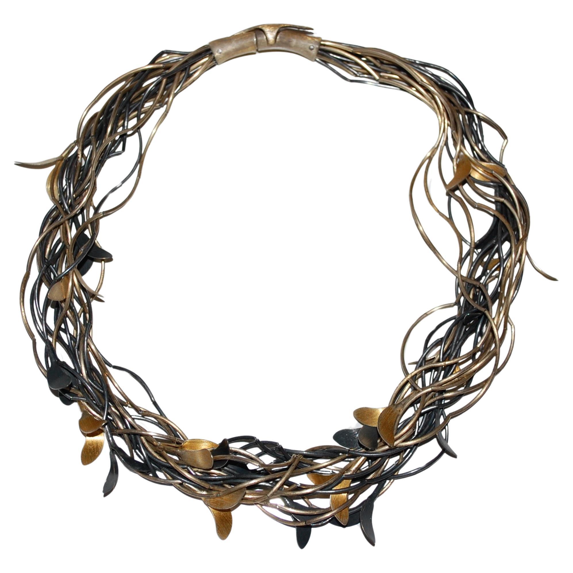 Sterling silver and gold plated multi strand leaf necklace with earrings. Hand made art jewelry by Alicja and Jan WYGANOWSK. A Polish family business which has been creating unique jewelry continuously since 1987. The strength of the brand stems