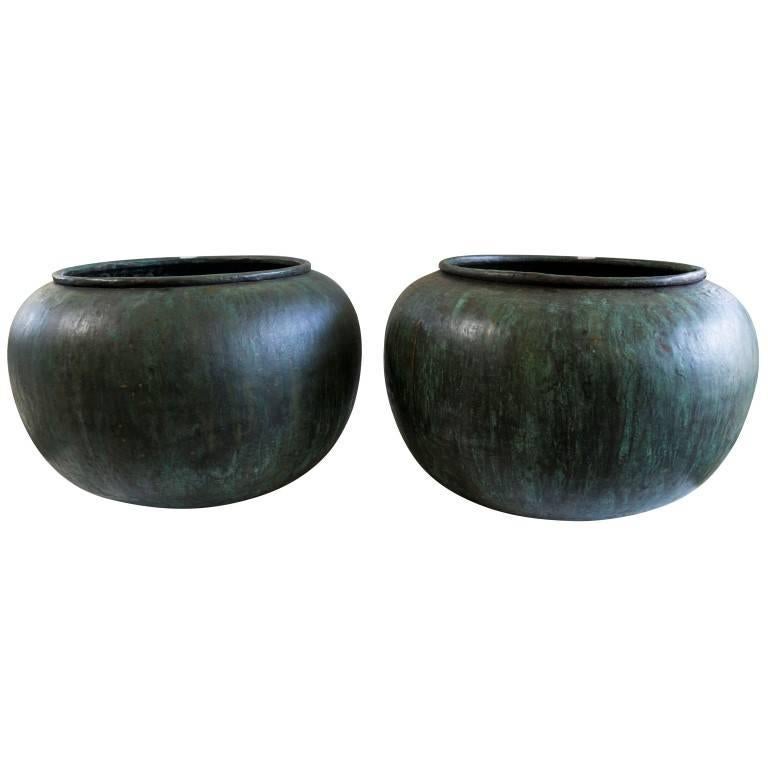 The tomato shape and oxidized copper blue patina give these vessels an alluring quality.