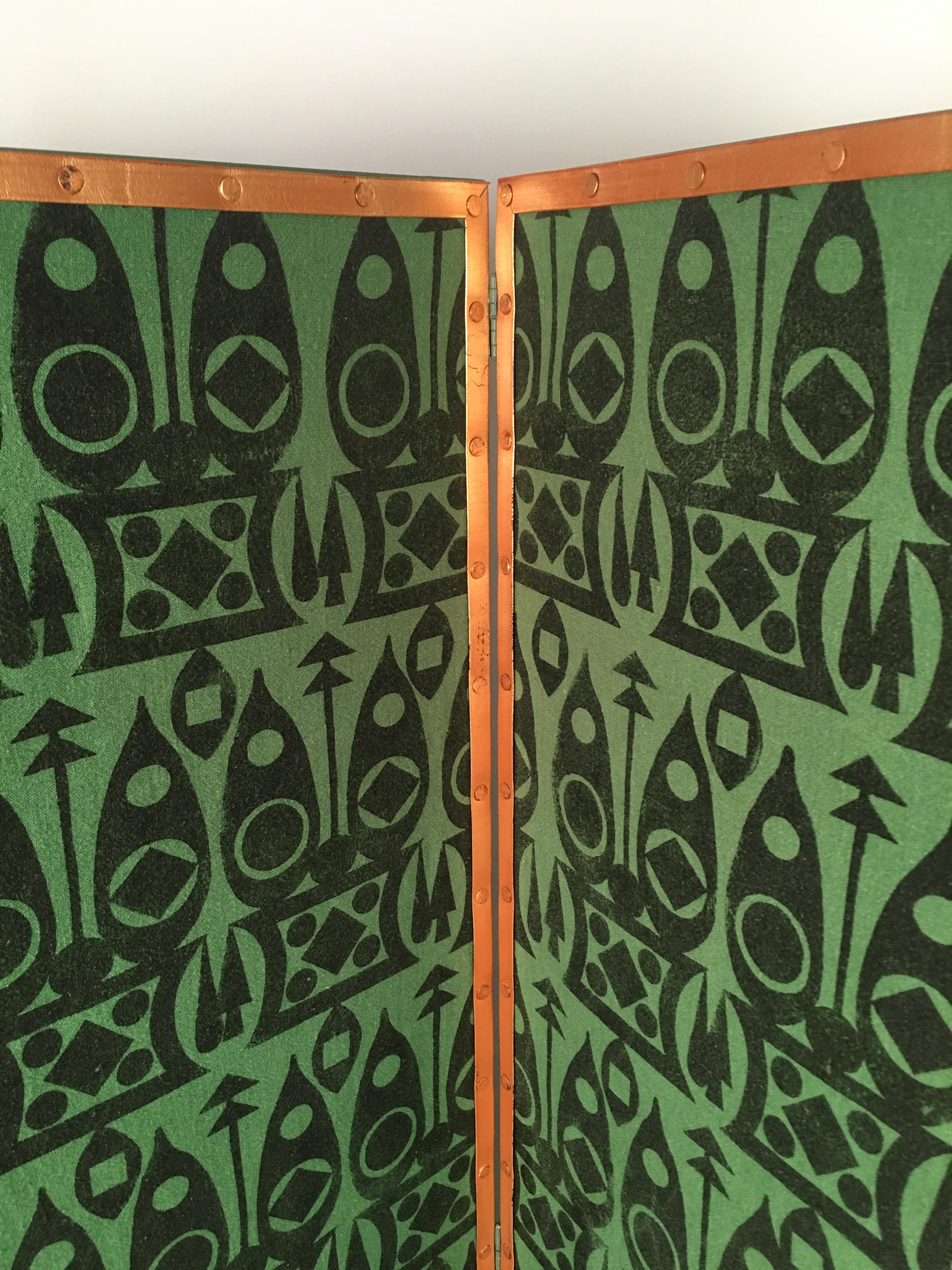 A four panel screen with beautifully made, entirely hand block printed fabric in the geometric Aquitaine pattern, in warm black on evergreen linen, handmade by artist Charles Dort in the studios of Drusus Tabor in coastal Massachusetts. Each design