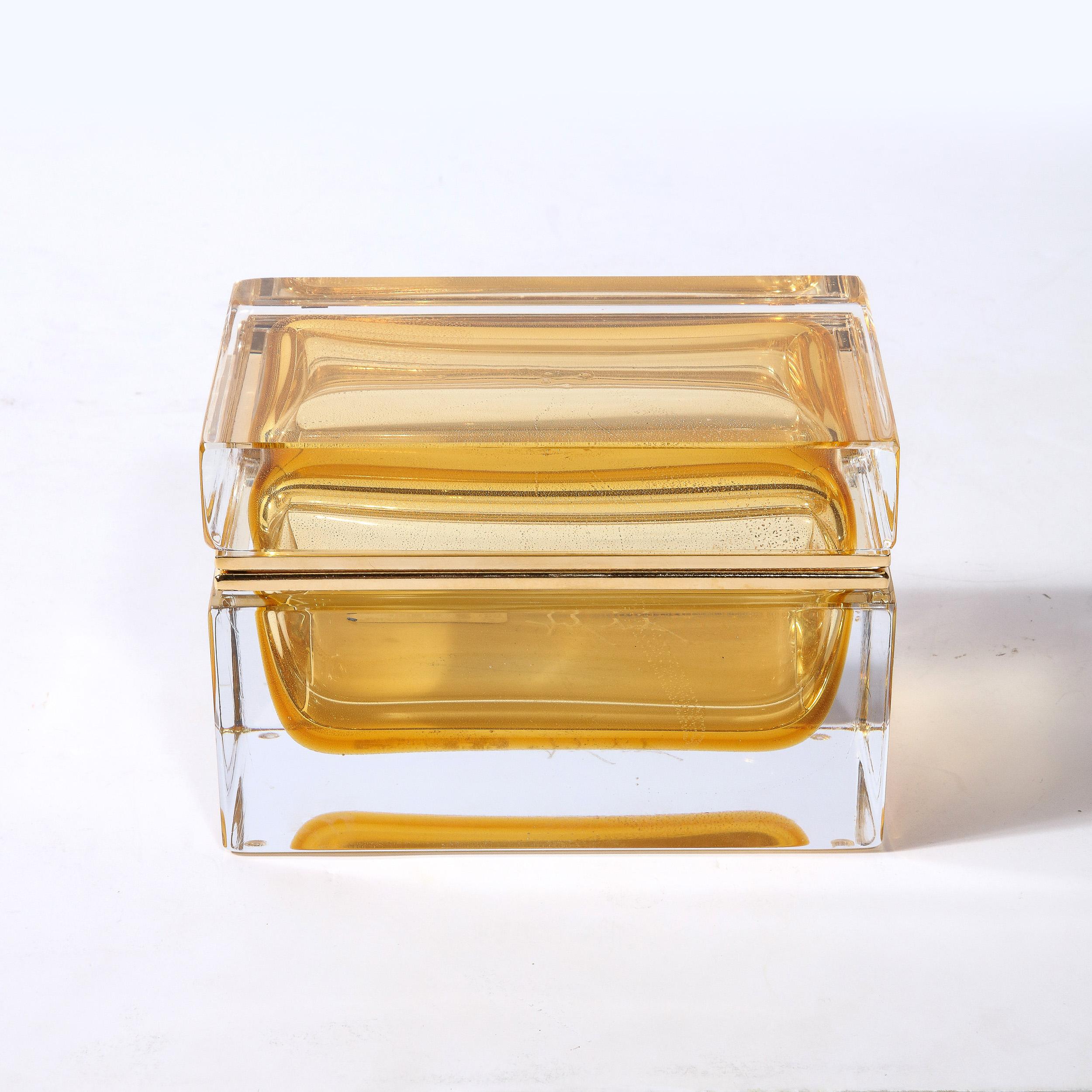This beautiful modernist decorative box was realized in Murano, Italy- the island off the coast of Venice renowned for centuries for its superlative glass production. It features a volumetric rectangular body with a translucent Murano glass exterior