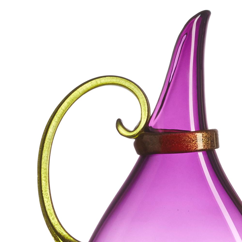 Designed to fit on narrow mantles, ledges and window sills, the petite Amethyst Vetro Vero Flat Pitcher is blown and pressed by hand during the glassblowing process to inspire layered displays of translucent color. Hand-sculpted handle, wrap, and