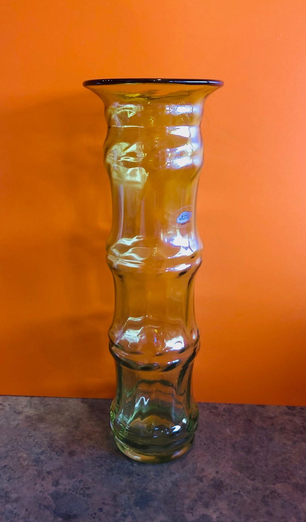 Hand blown yellow / gold art glass vase by Don Shepherd for Blenko Glass, circa 2005. This bamboo shaped design was initially introduced for one year by Don Shepherd in the late 1970s, the design was reintroduced in 2003 in a smaller foot print. A