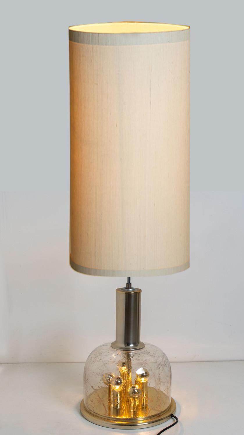 Doria hand blown glass sphere on brass base lamp, Germany, circa 1970. This exceptional artefact of modern design reflects the extreme interest in modernism across Europe during this period. This unique lamp not only functions as light source but