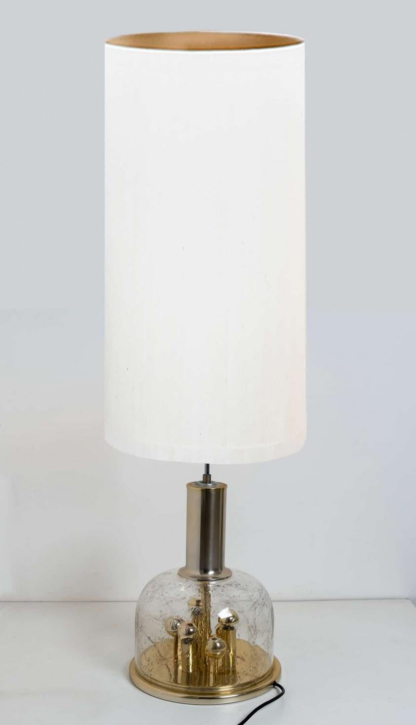 Doria hand blown glass sphere on brass base lamp, Germany, circa 1970. This exceptional artefact of modern design reflects the extreme interest in modernism across Europe during this period. This unique lamp not only functions as light source but