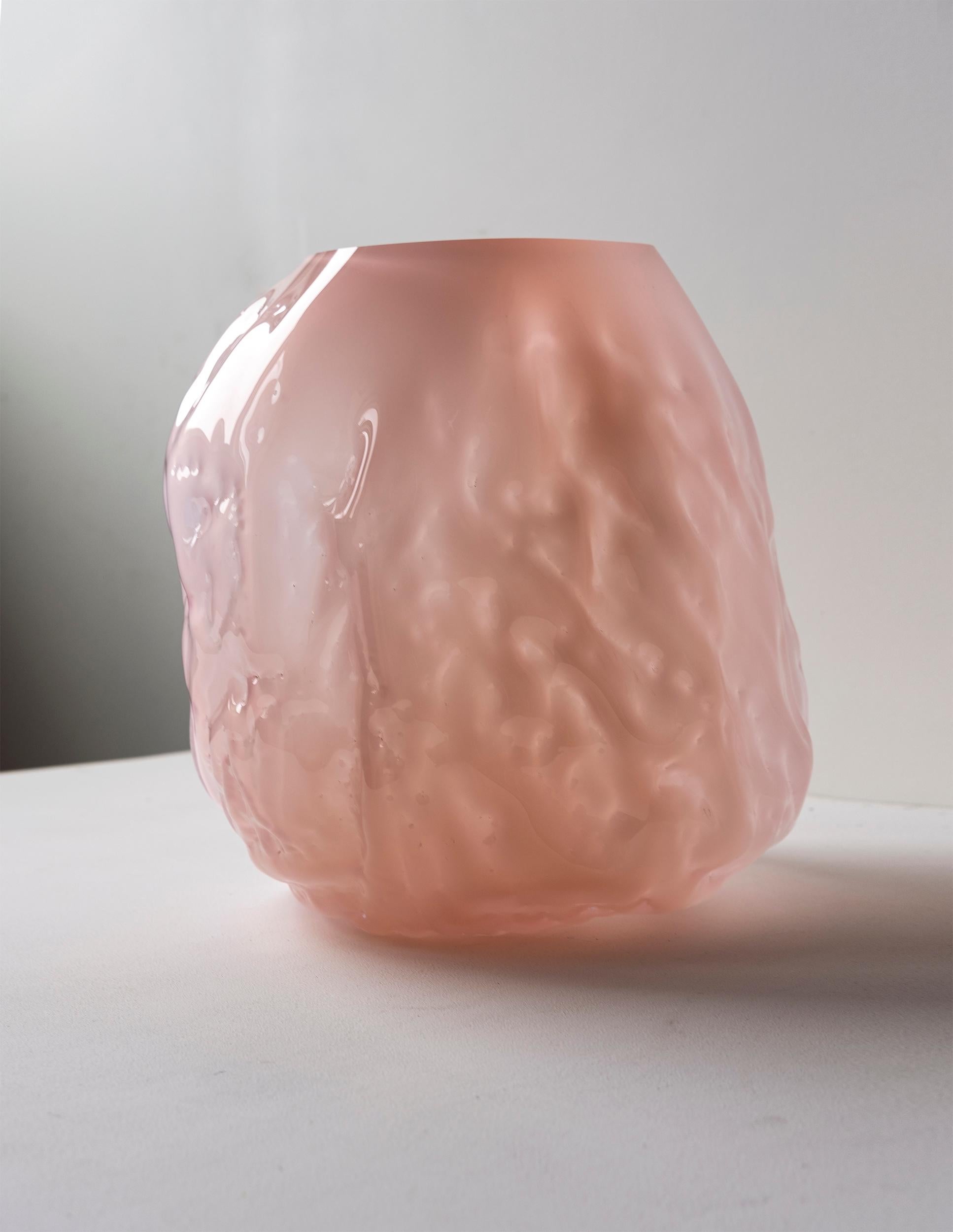 Hand blown glass vase made in forms of soft clay that are shaped by hand just before blowing the glass into the form. The process makes all pieces unique and gives them a wrinkled surface. NOTE, small parts of clay from the production might be