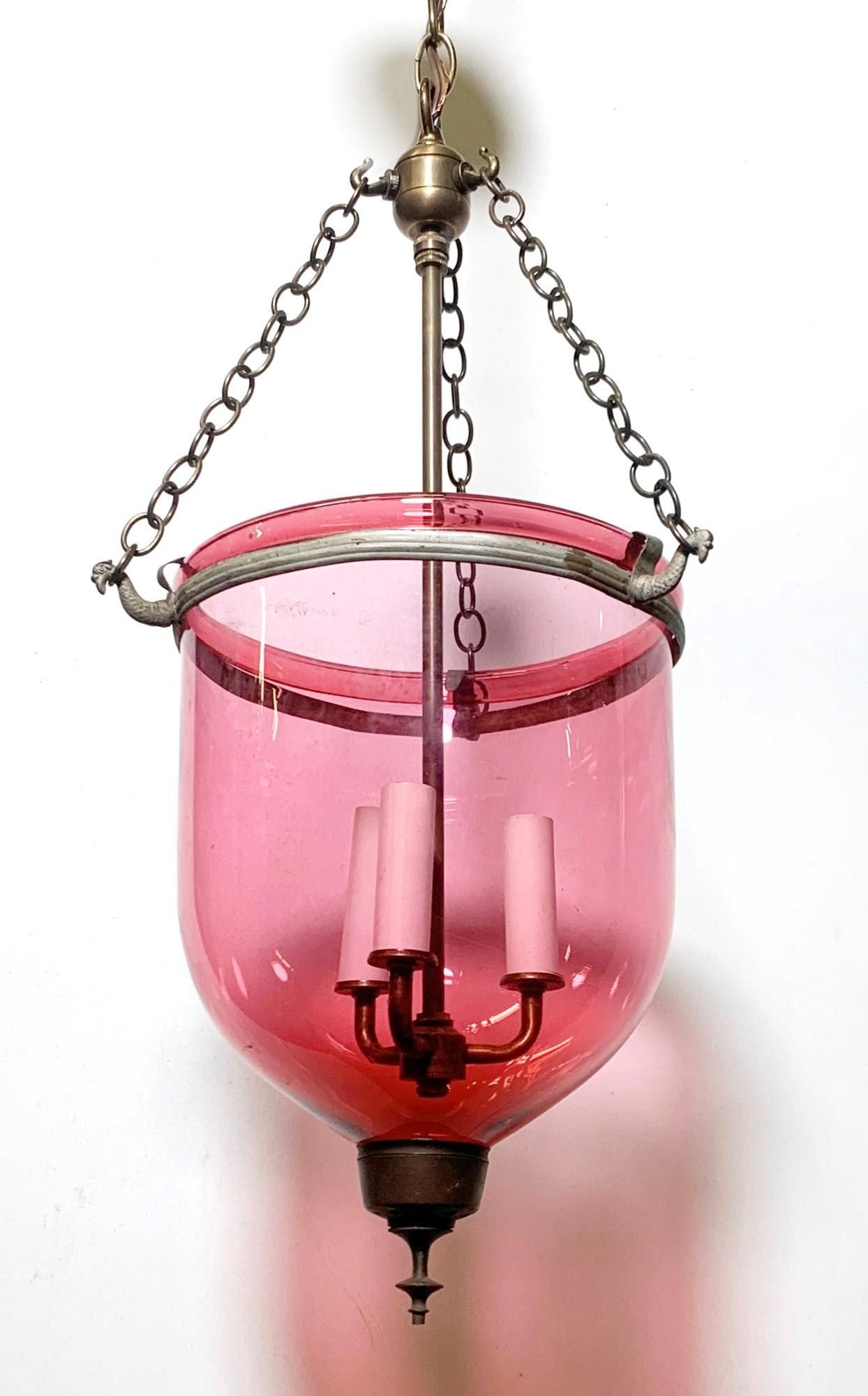 Early 20th century antique hand blown cranberry red bell jar pendant light. Restored with brass finished hardware.