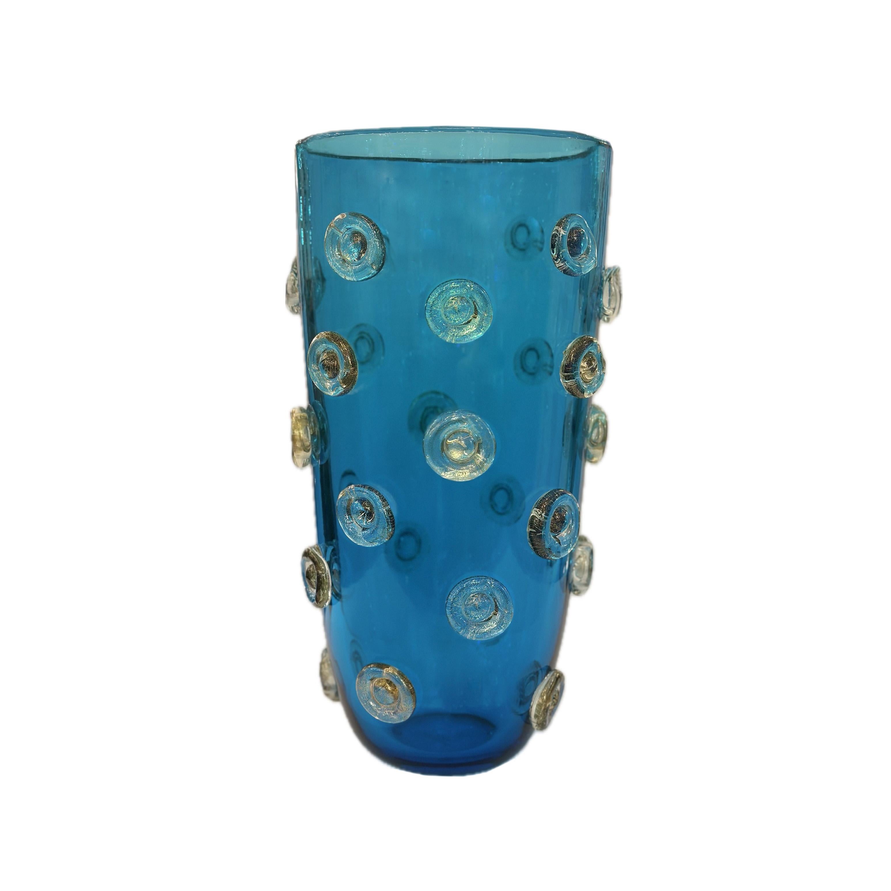 Deep blue color Murano glass vase decorated with applied dot design in clear glass with gold leaf inclusions. Italy, 2023

This vase is currently available  in our NYC showroom. Thsi design is also available in Green and Amber color glass. Please