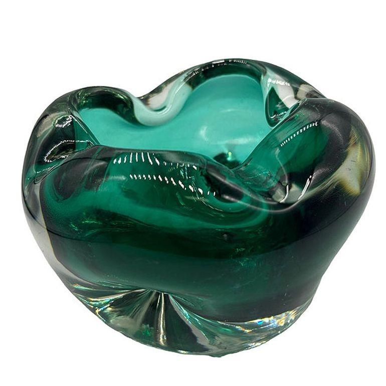 Mid-century emerald hand-blown Murano art glass ashtray cased in green and transparent colors featuring a polished bottom like the best of Venetian glass. The ashtray features rounded forms with smooth flowing edges in a handkerchief shape and has 4
