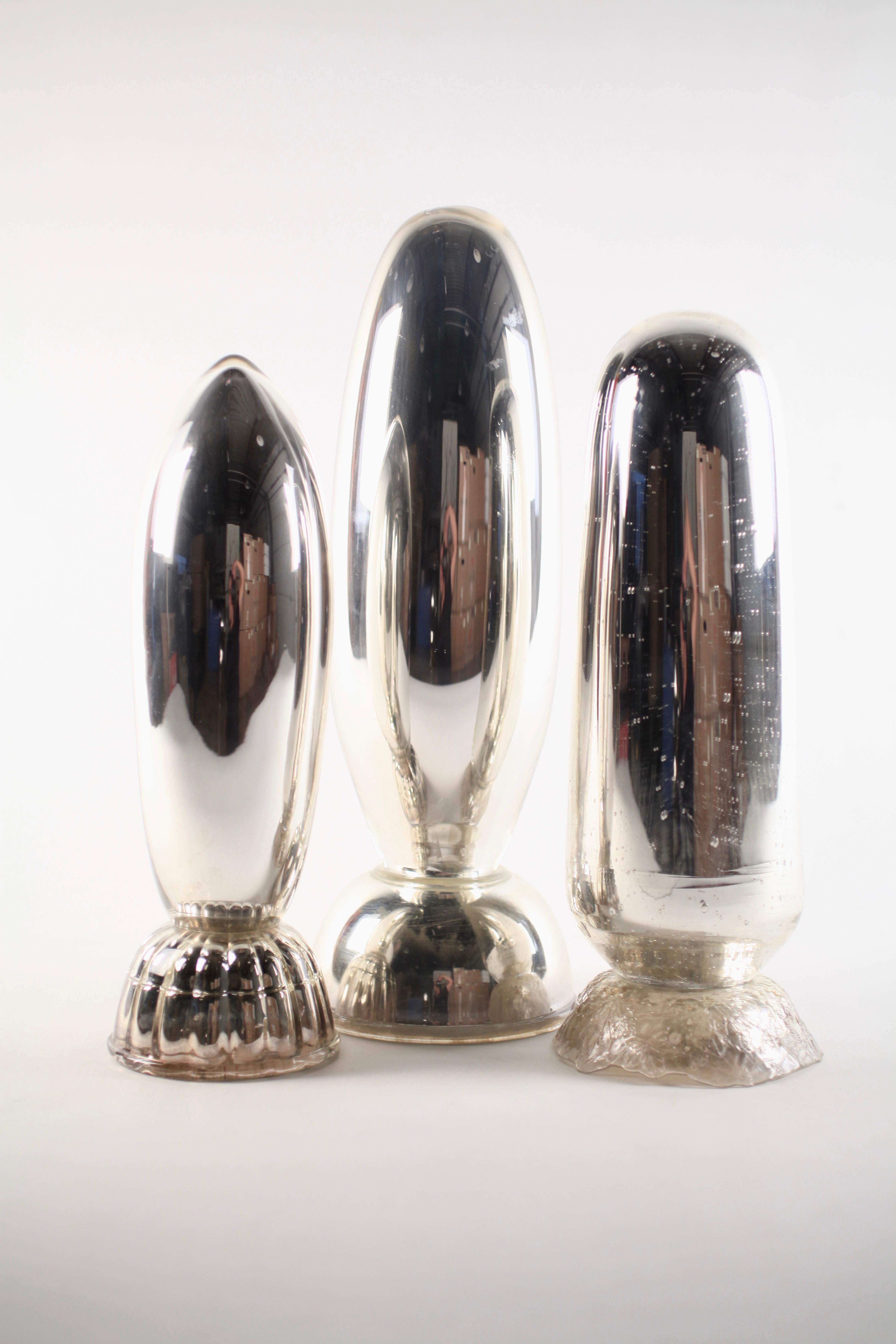 Hand blown and mirrored bomb trio #3, Sculptures by Elizabeth Lyons 2003-2010
These limited-edition sculptural pieces began as components of a larger installation created in 2003. Each piece is hand blown, some with found glass components added,