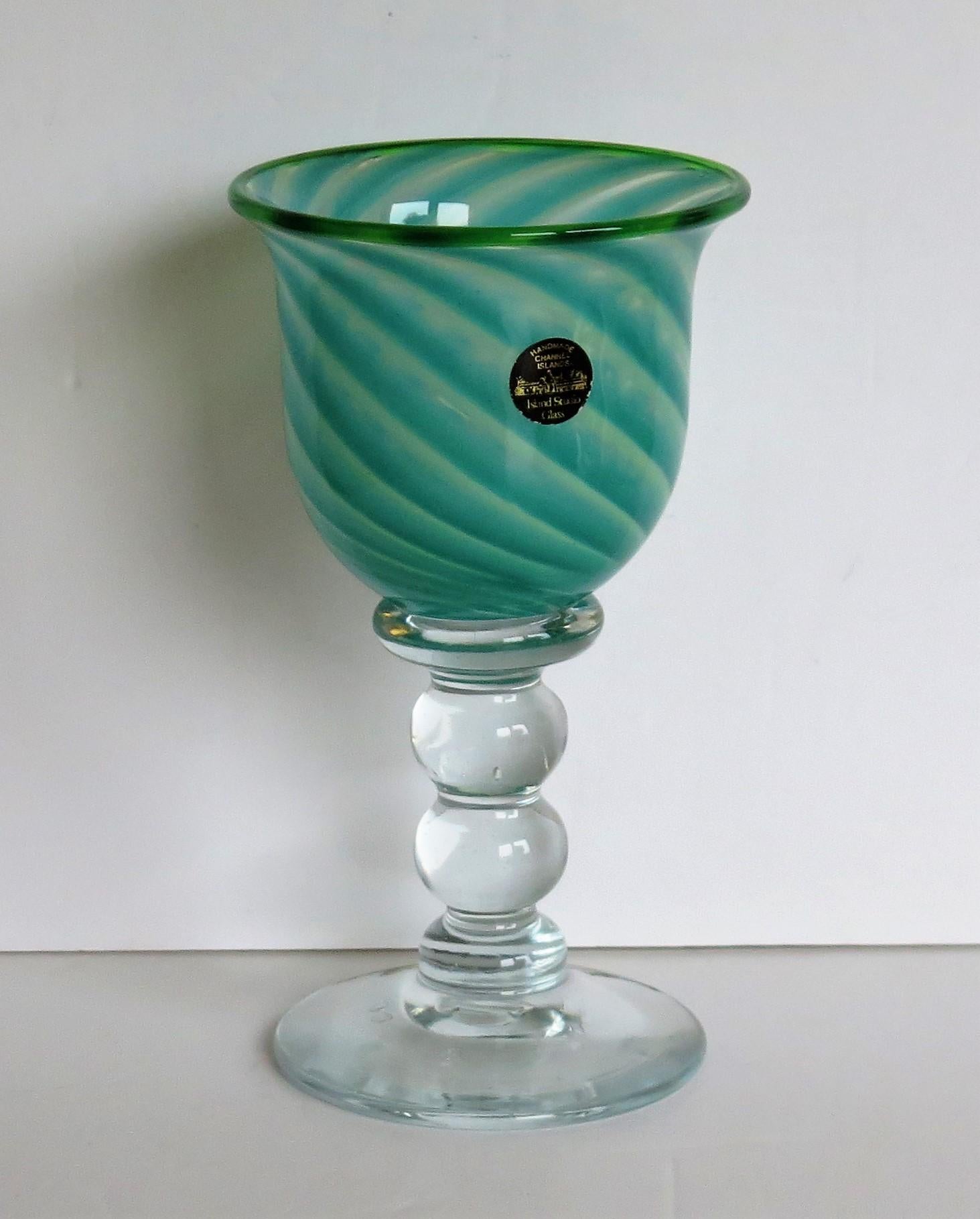This is a very good large hand blown glass goblet, made by Island Studio Glass of Guersey, Channel islands, dating to the late 20th century, circa 1985.

The glass goblet is beautifully handmade. The ogee shaped bowl is a lovely green / blue swirl