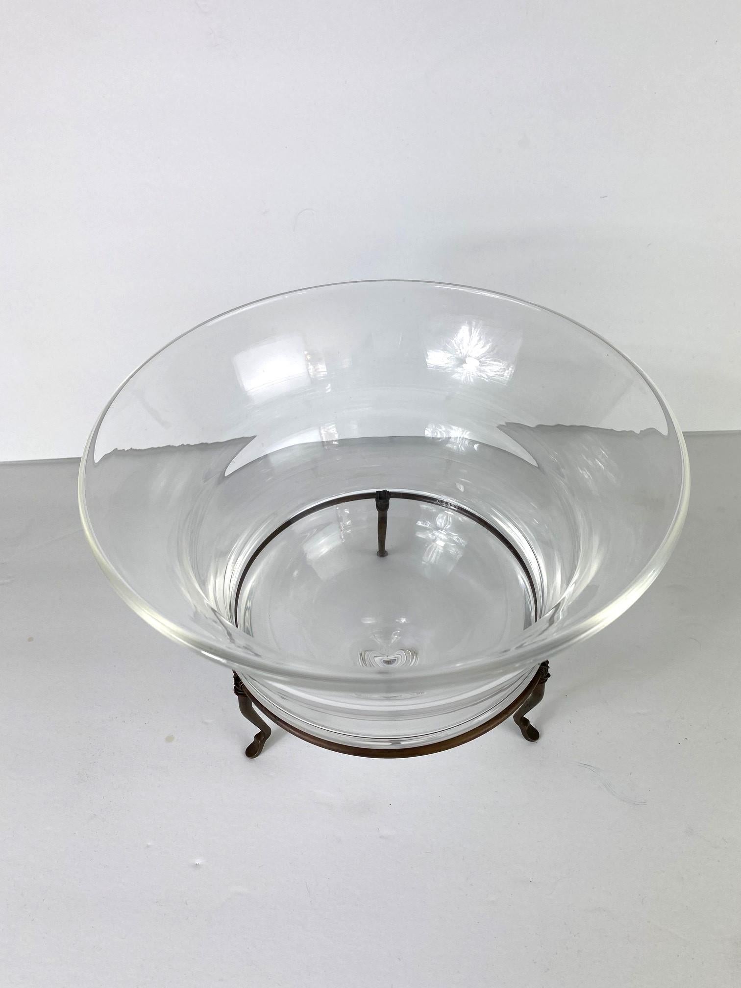 Hand-blown round-shaped bowl with a metal stand.