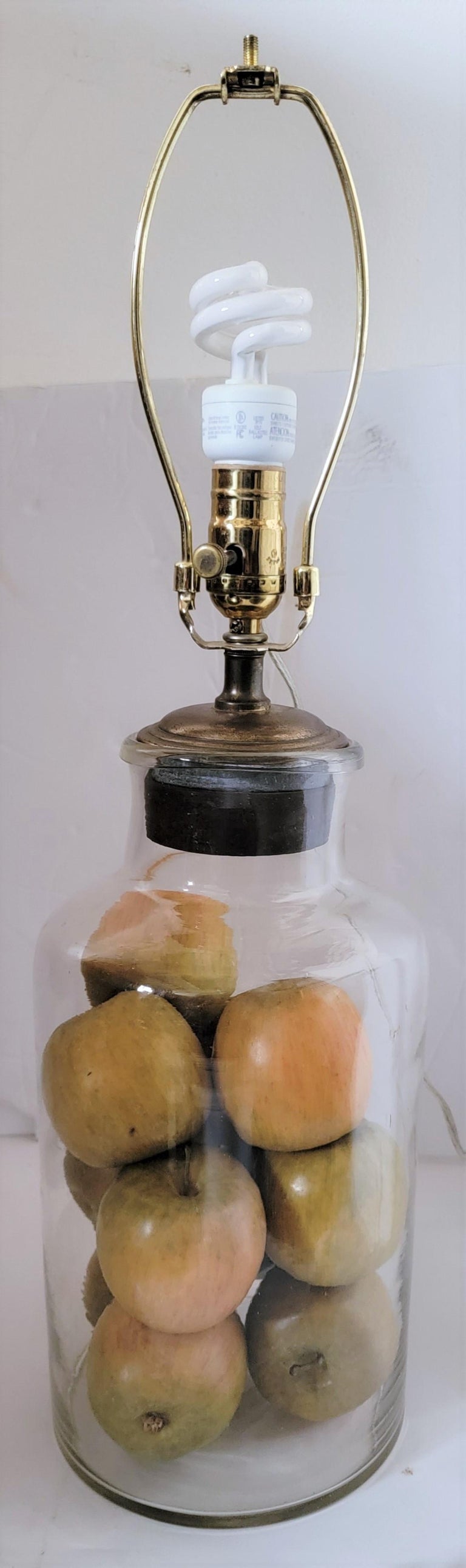 Hand blown lamp with fruit and star punch tin shade

 bottle/vase measures - 7 diameter x 14 high

the shade measures - 14 diameter x 10.5 high 

Full measurements - 26.5 high (with Finial) 14 diameter.