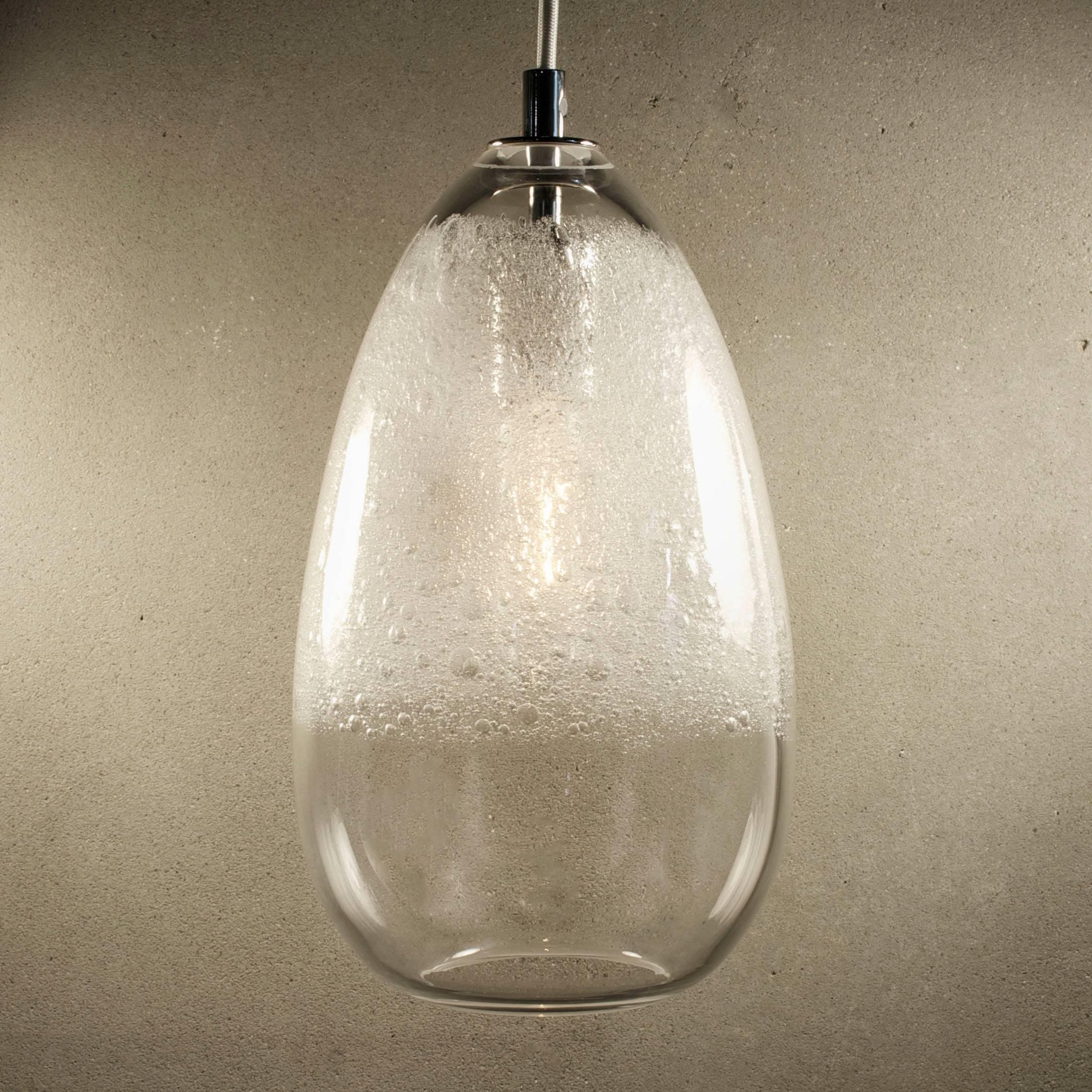 These works continue the language of contrast of the lattimo and banded lines, but use a swath of textured whipped glass. This is then paired with a selection of soft colors and simple forms. The bubbles cloud and diffuse the bulb and add elements