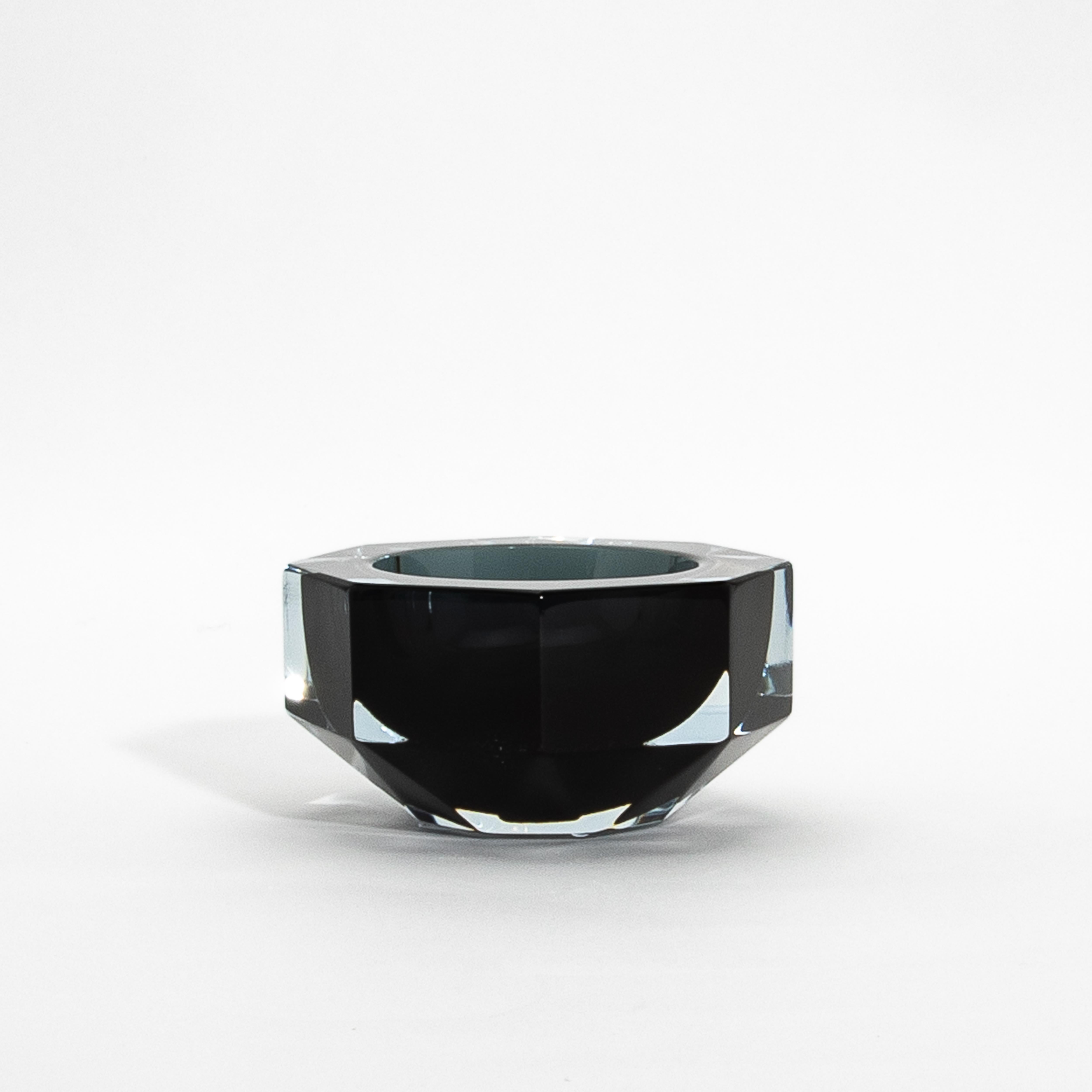 Dieser mundgeblasene Aschenbecher aus Murano in einem raffinierten Grauton verkörpert die Eleganz der venezianischen Glaskunst. Das facettierte, achteckige Design reflektiert das Licht wunderschön und schafft ein faszinierendes Spiel von Tiefe und
