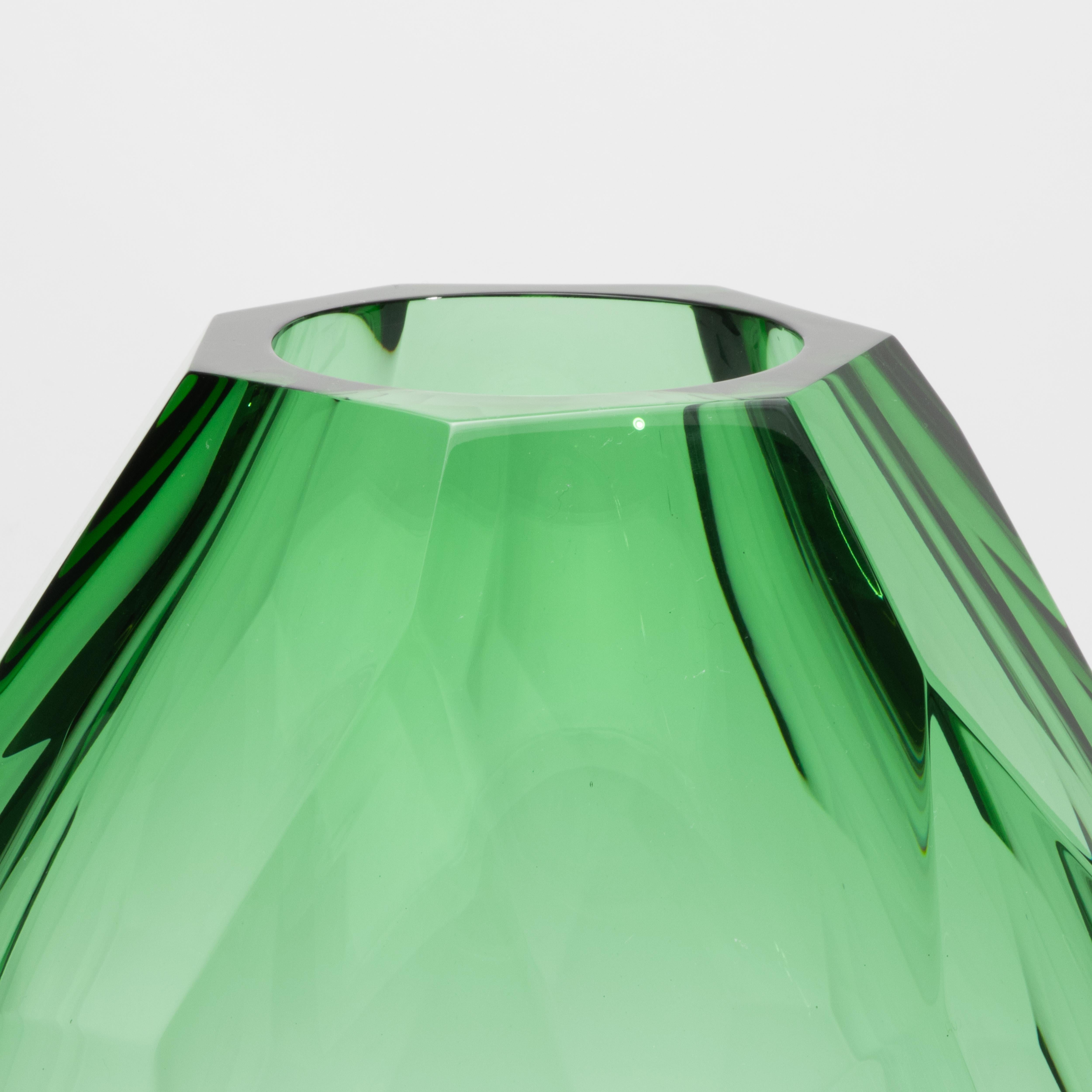 Bold yet impossibly refined, this tall hand-blown Murano barrel vase in emerald green is a masterwork of Venetian glass artistry. Its elongated faceted form evokes the precision of fine gem cutting, with each angled plane capturing and refracting