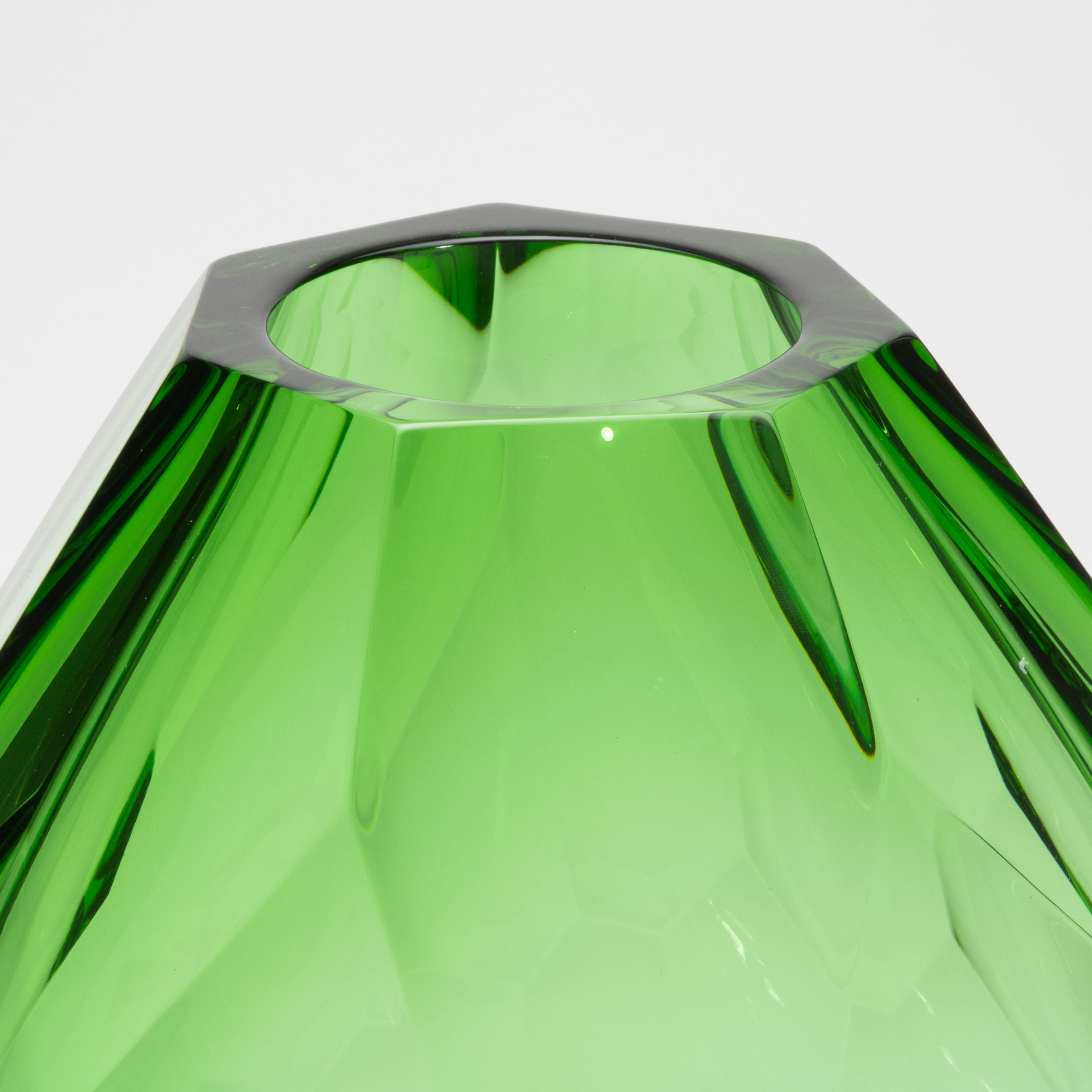 Bold yet impossibly refined, this tall hand-blown Murano barrel vase in emerald green is a masterwork of Venetian glass artistry. Its elongated faceted form evokes the precision of fine gem cutting, with each angled plane capturing and refracting