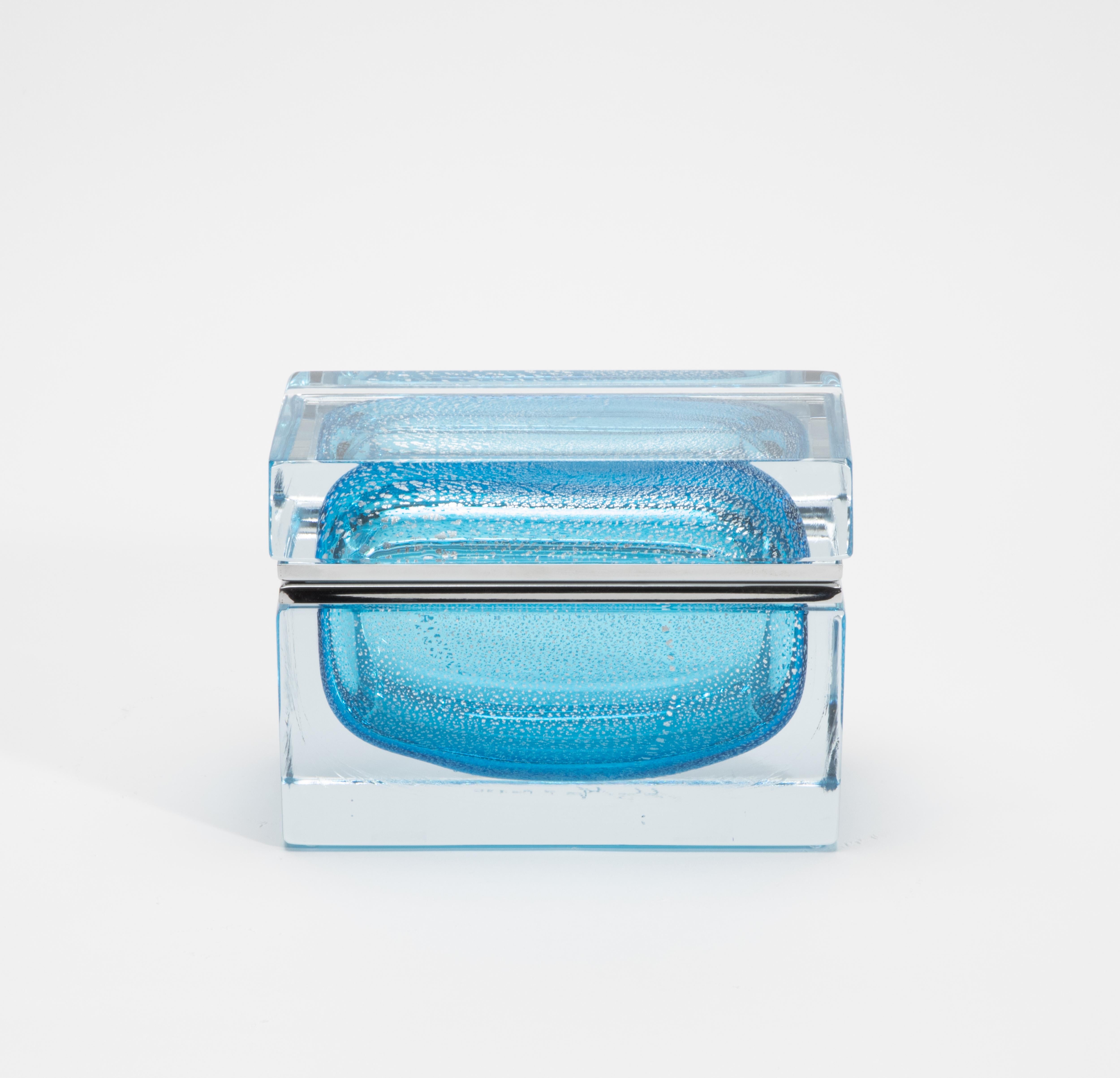 An exquisite showcase of contemporary Murano craftsmanship, this hand-blown giant box in aqua blue is a sculptural treasure that blends clarity, luminosity, and refinement. Encased in a thick, crystal-clear silhouette with softly rounded corners,