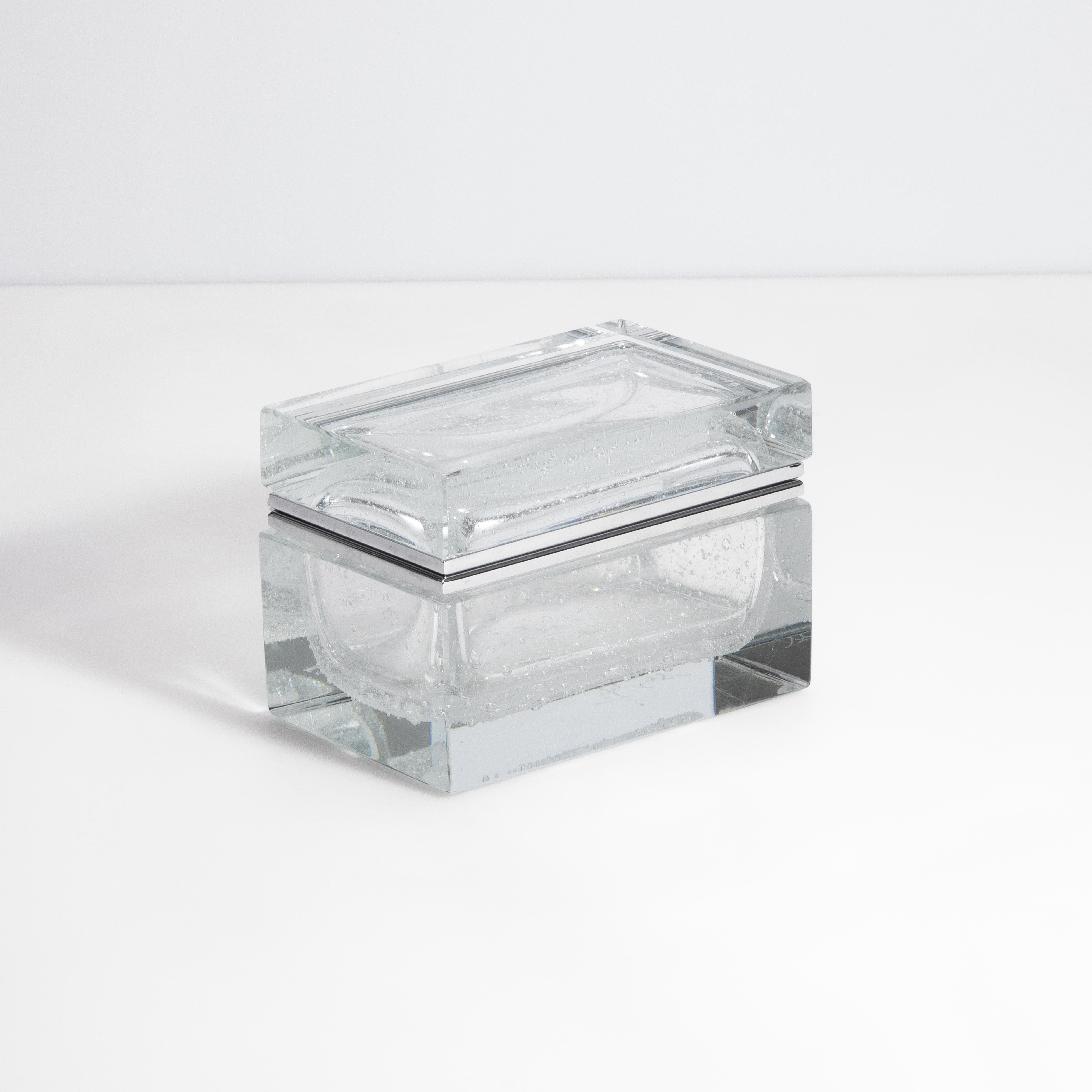 This Pulegoso Murano glass box is a captivating fusion of artistry and functionality, crafted on the renowned Venetian Island of Murano. Distinctive for its unique texture, the Pulegoso technique involves infusing countless tiny air bubbles into the