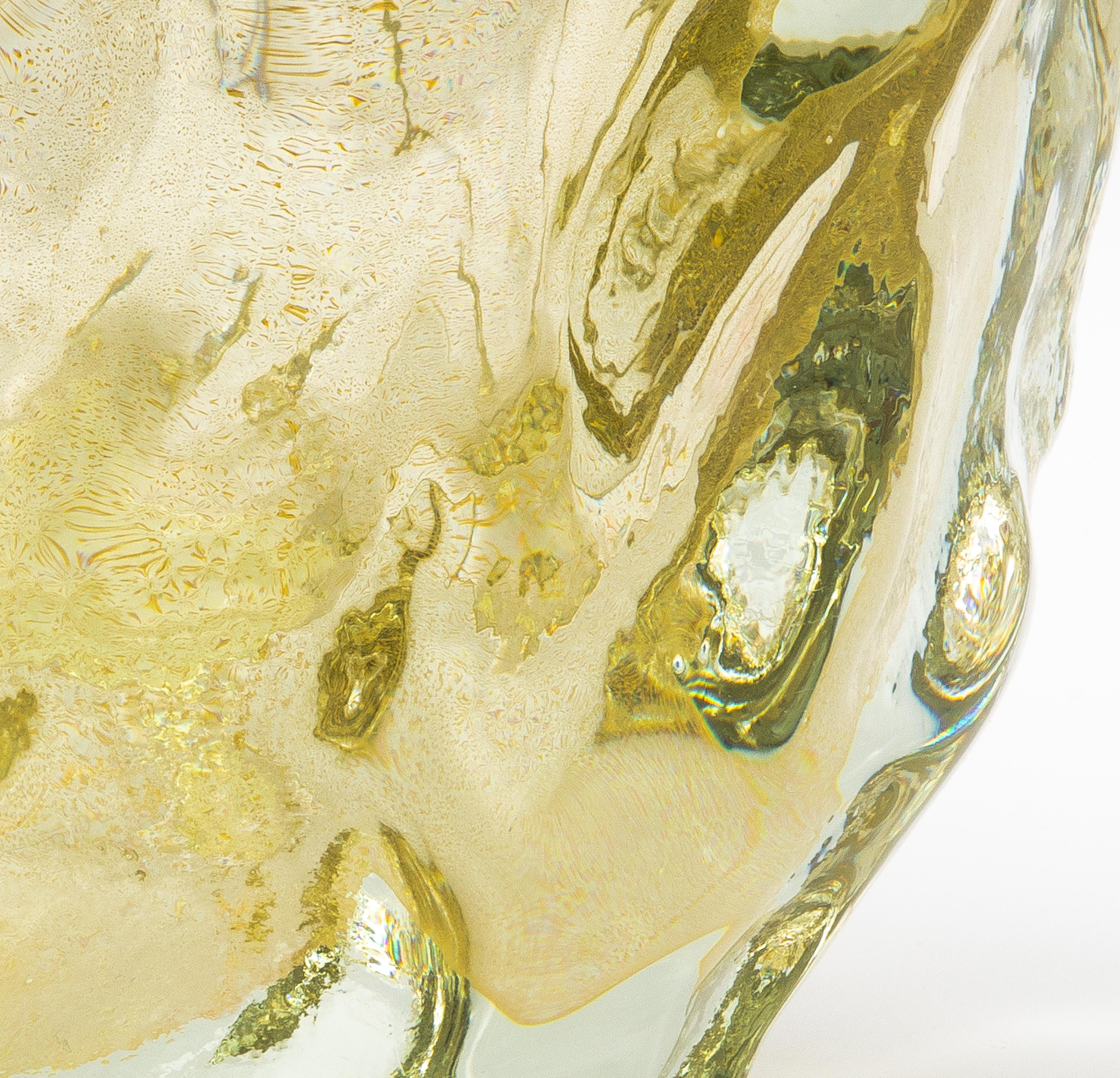 The Murano Burri Vase in clear with 24-karat gold flecks is a true testament to the unparalleled artistry of Murano glassblowers. Each vase is hand-blown, showcasing organic, freeform curves that appear almost fluid, as if frozen in a moment of