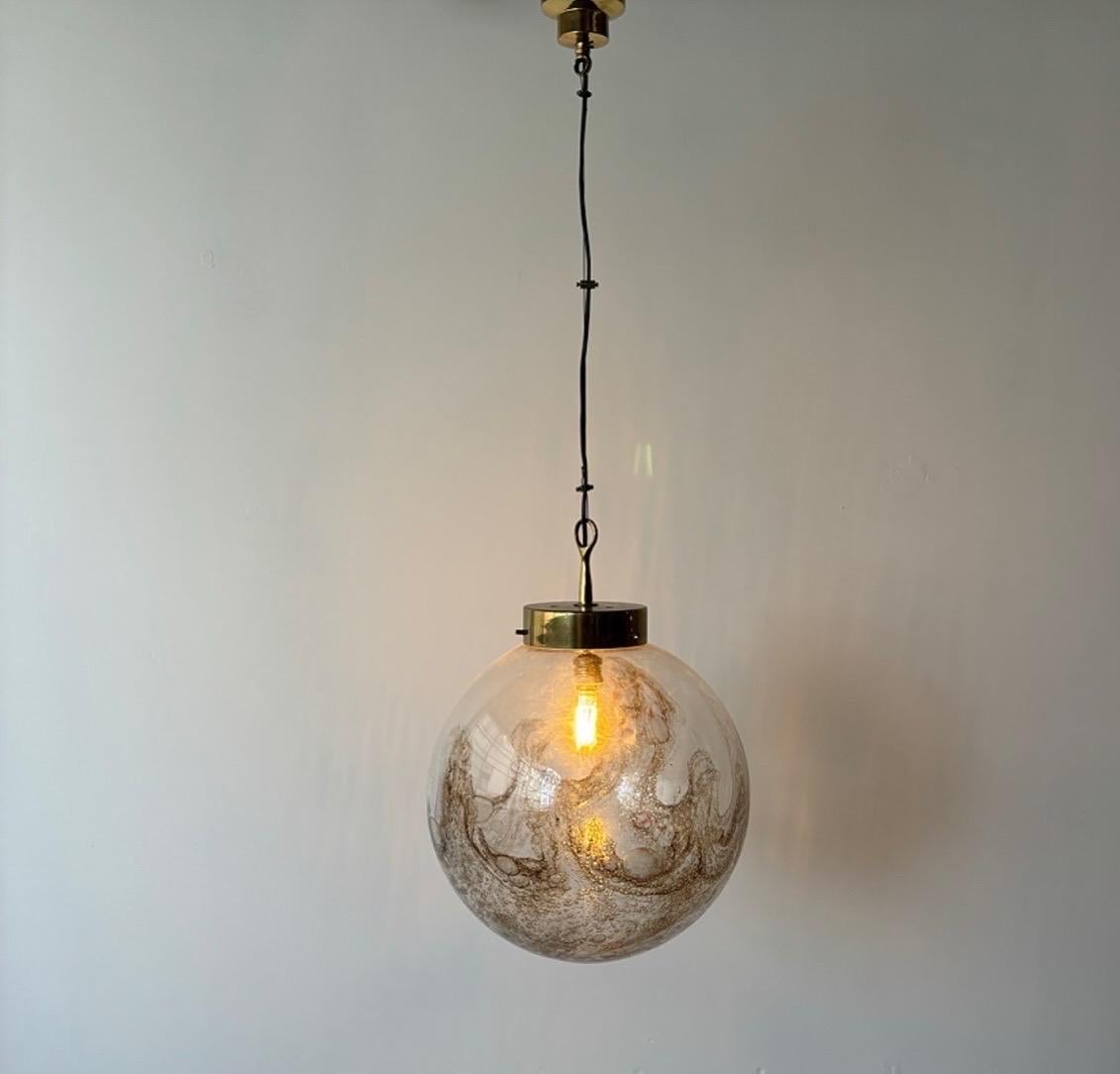 Hand Blown Murano Glass and Brass Pendant Lamp by La Murrina, crafted in 1970s Italy, exemplifies the exquisite artistry and craftsmanship of the era. This lamp features hand-blown glass with delicate air bubbles, creating a mesmerizing play of
