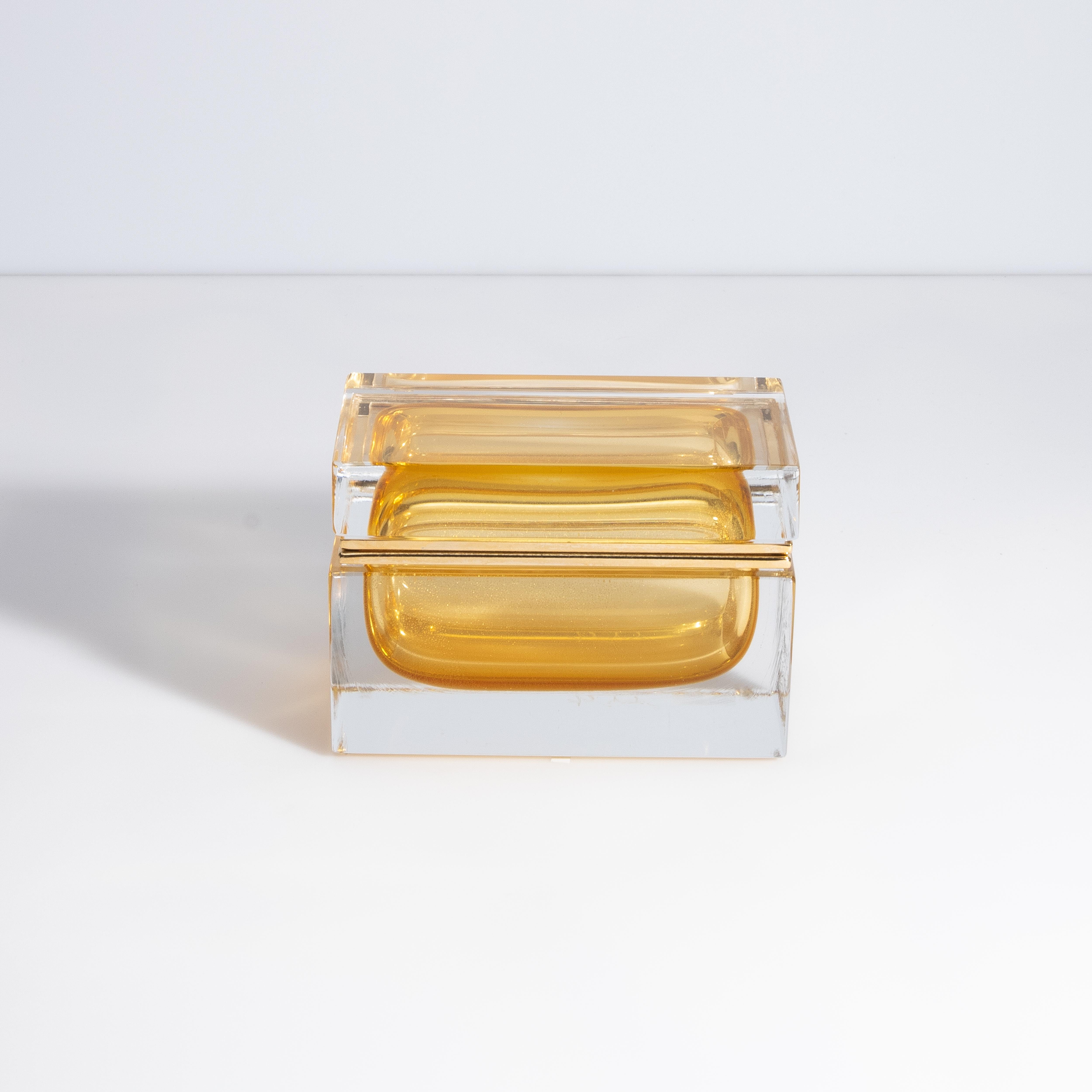 The marriage of amber and 24-karat gold lends a mesmerizing allure to this enchanting hand-blown glass box from Murano, Italy.  The warmth from this piece emanates a sense of luxury and sophistication, which is an absolute delight for the eye.