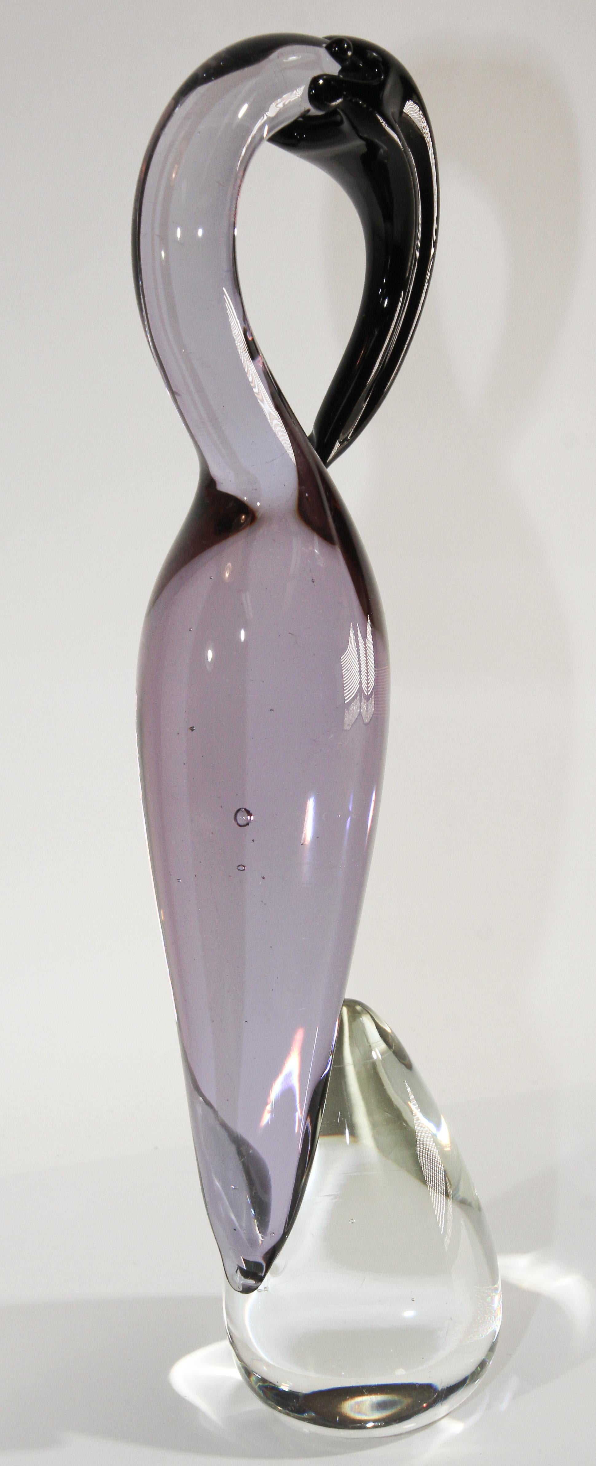 Vintage collectible Murano art glass hand blown sculpture of a crane in clear and purple colored glass.
Handcrafted beautiful Mid-Century Modern hand blown art glass Italian figurine decorated in clear and light pink purple and black.
This exquisite