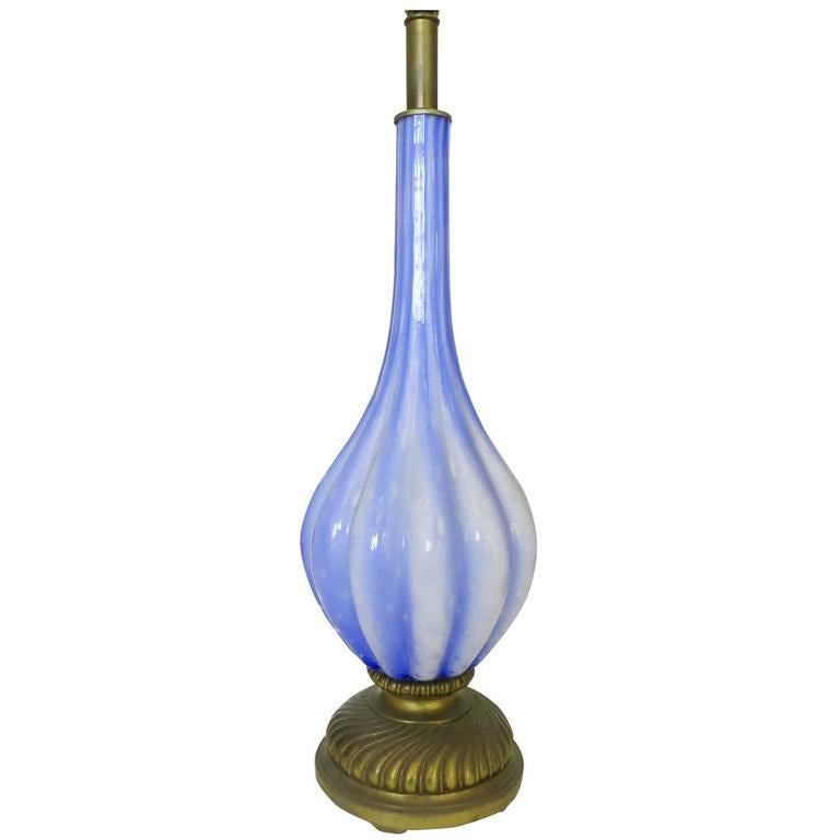 Elegant hand-blown semi clear blue and white Murano glass table lamp much in the style of Barovier e Toso. The large round hand blown center piece with controlled bubbles fixed to a decorative brass base with brass accents.