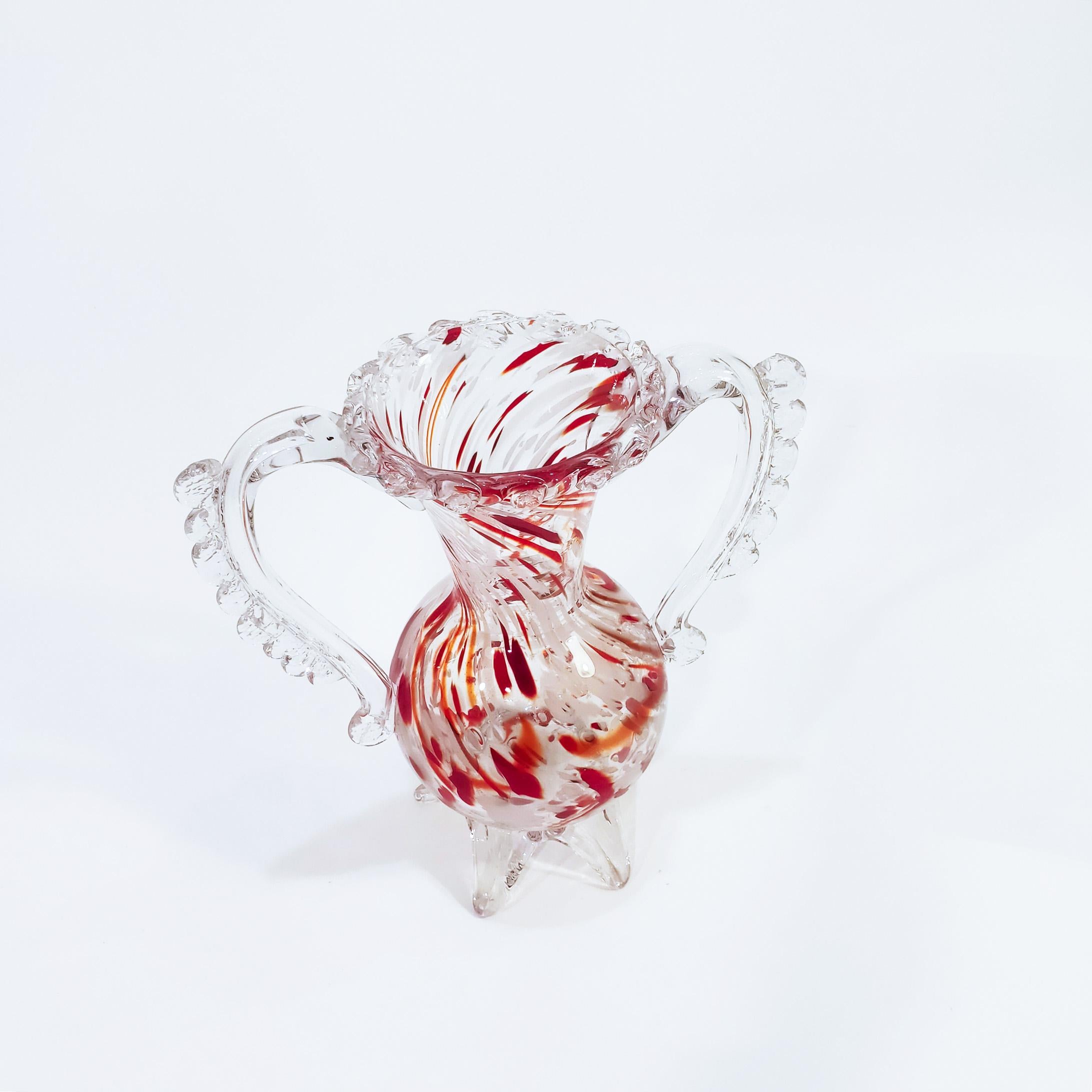 Handcrafted glass vase from the 50s, produced in Mallorca by the Gordiola glass brand. Blown and handmade, with reddish and white colors swirling throughout the body with a transparent background. Small natural production crack in the union of a