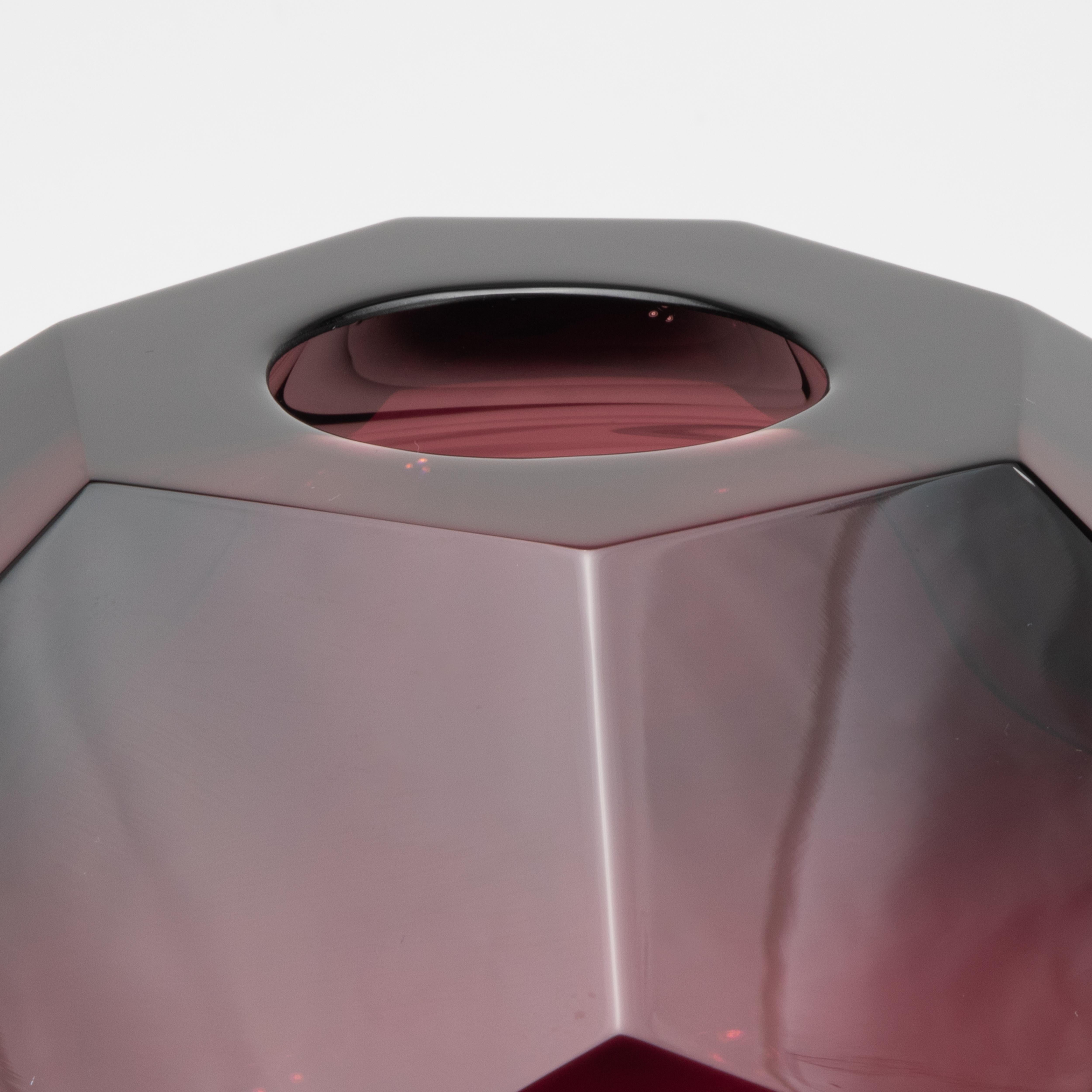 A breathtaking fusion of art and alchemy, this hand-blown Murano globe vase in deep amethyst transforms light and shadow into sculpture. Meticulously faceted like a gemstone, its spherical silhouette radiates sophistication from every angle. The