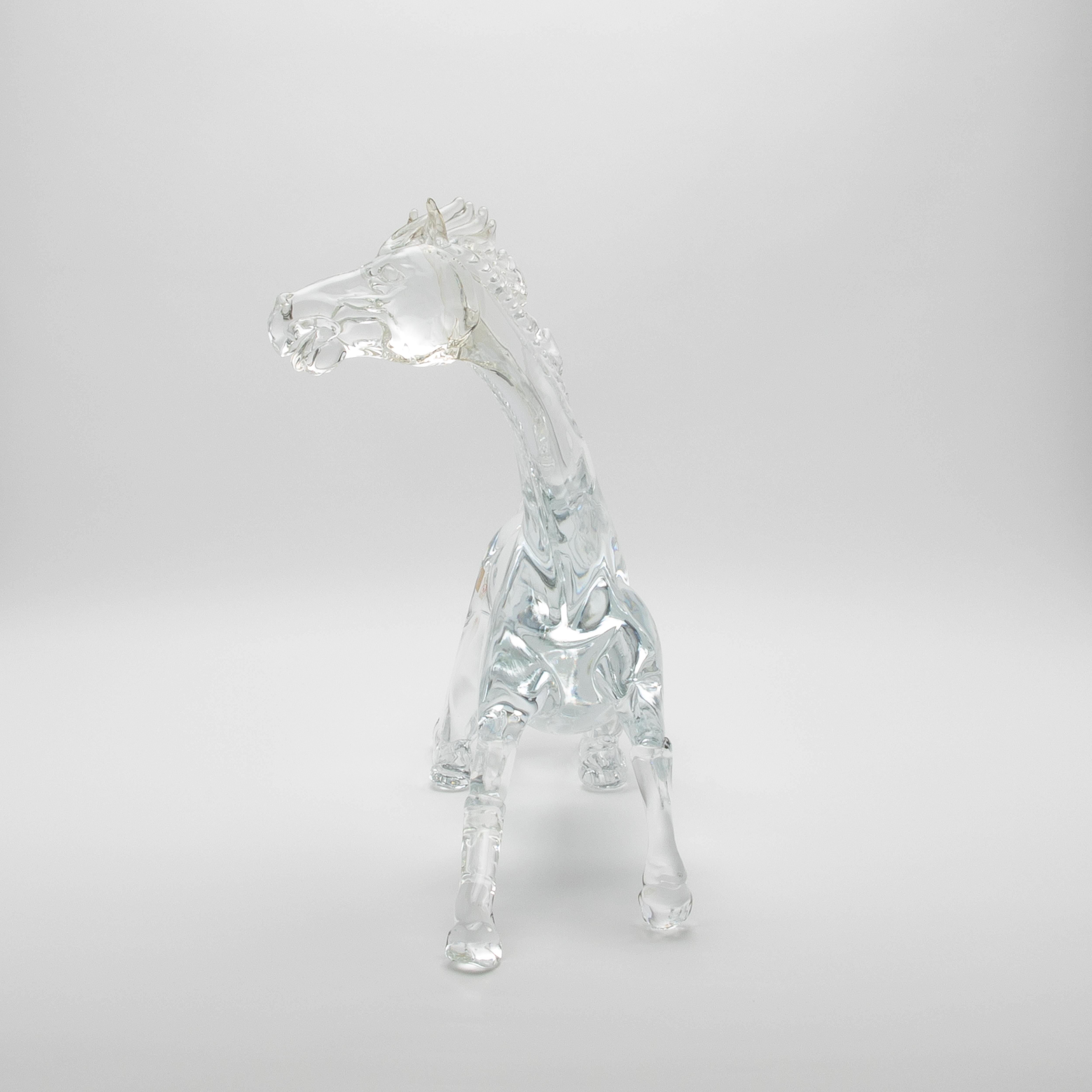 Crafted from the purest hand-blown Murano glass, this exceptional horse sculpture is a pinnacle of luxury artistry and refined design. Each curve and contour reflects the centuries-old mastery of Murano's renowned artisans, capturing the horse's