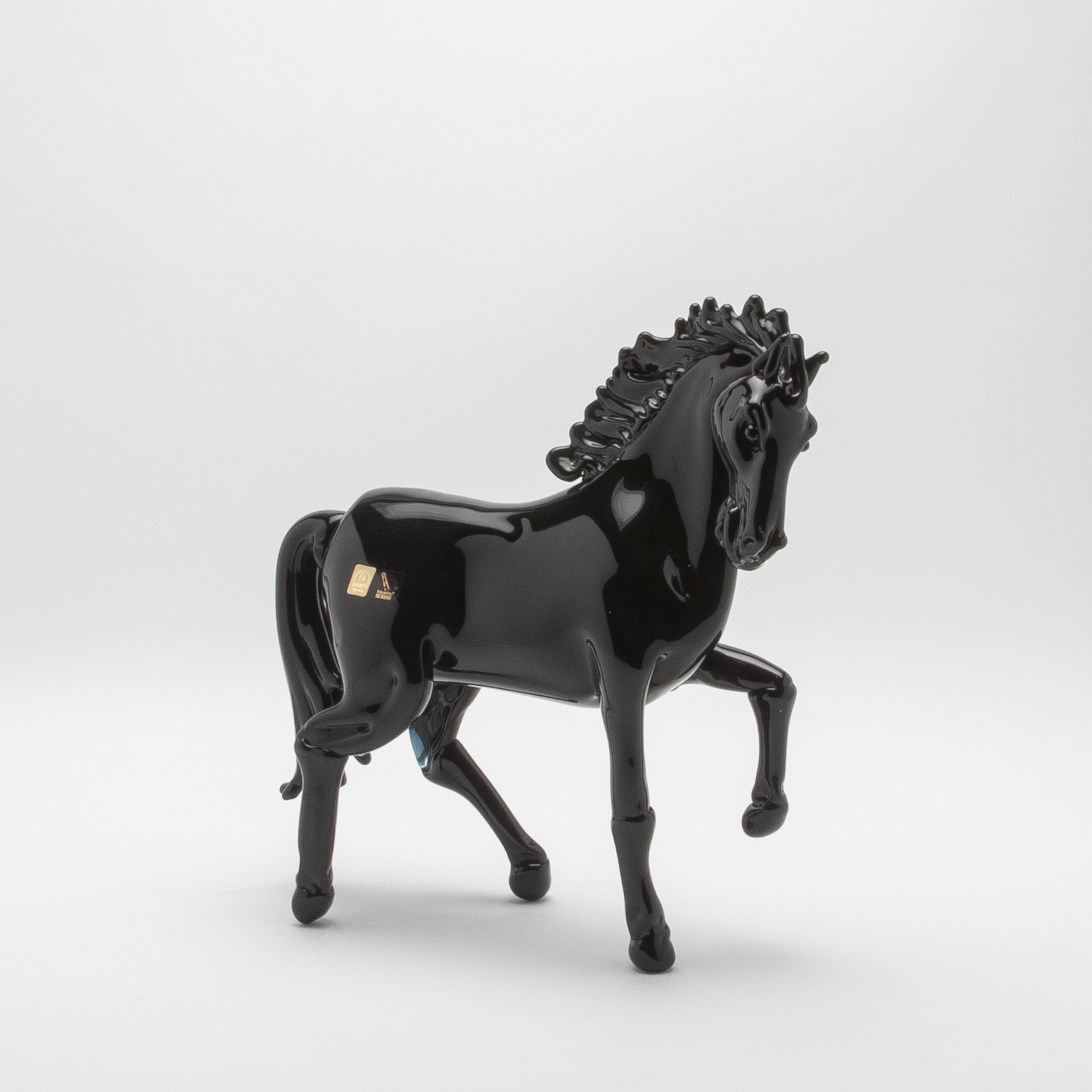 This hand-blown Murano glass horse sculpture, with its striking black finish, embodies the pinnacle of contemporary luxury and timeless artistry. Exquisitely sculpted by master artisans in Murano, Italy, the piece showcases their unparalleled skill