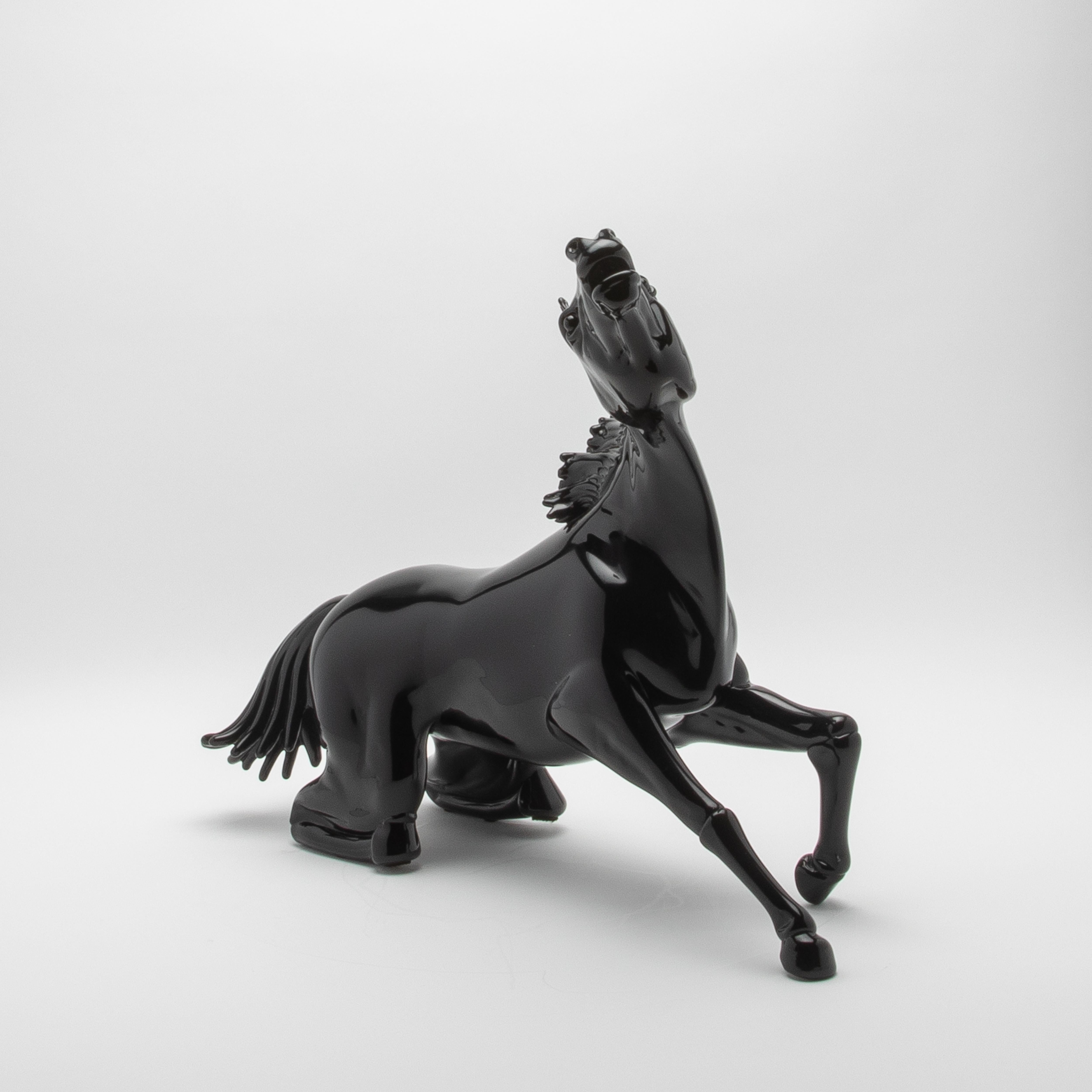 This hand-blown Murano glass horse sculpture, with its striking black finish, embodies the pinnacle of contemporary luxury and timeless artistry. Exquisitely sculpted by master artisans in Murano, Italy, the piece showcases their unparalleled skill