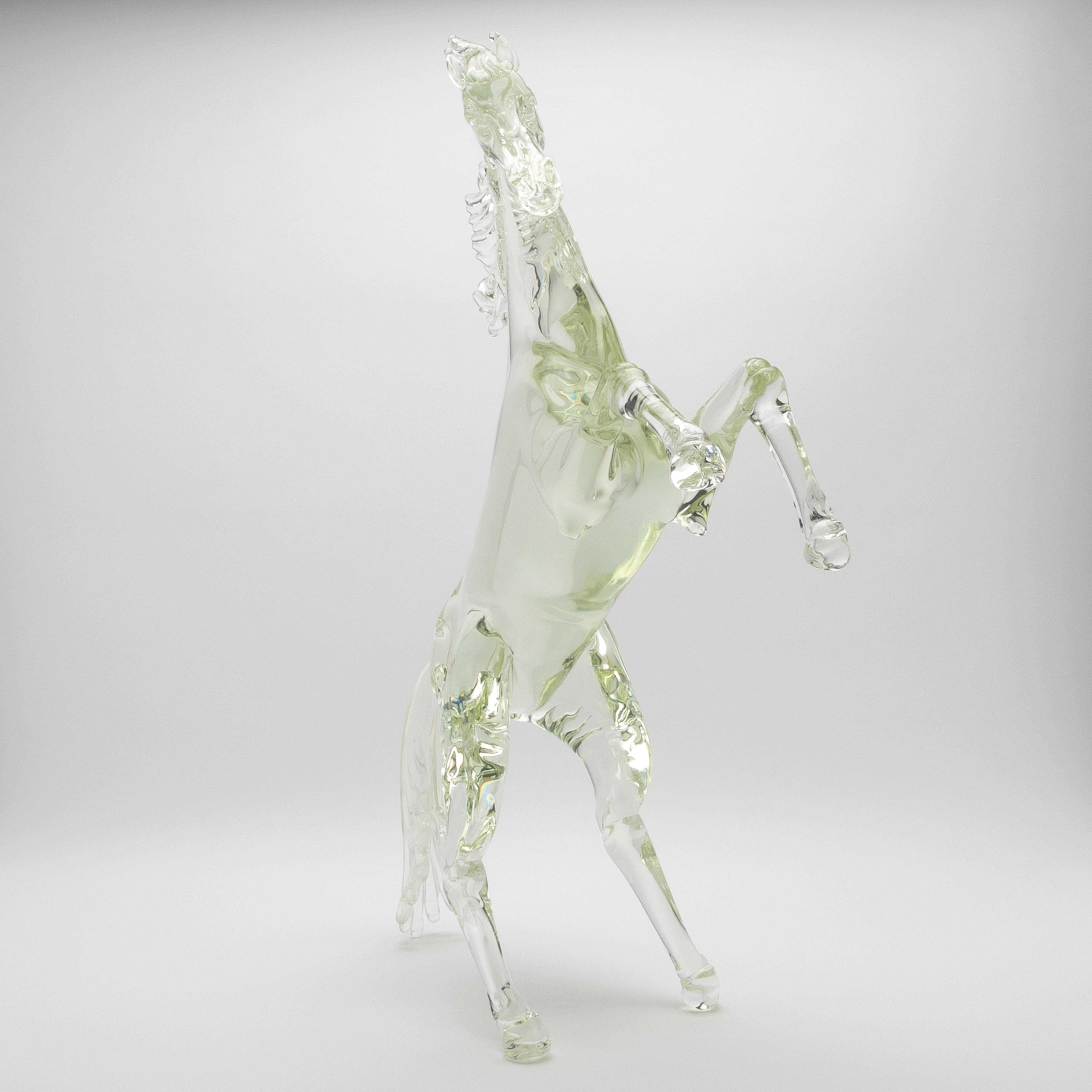 Crafted from the purest hand-blown Murano glass, this exceptional horse sculpture is a pinnacle of luxury artistry and refined design. Each curve and contour reflects the centuries-old mastery of Murano's renowned artisans, capturing the horse's