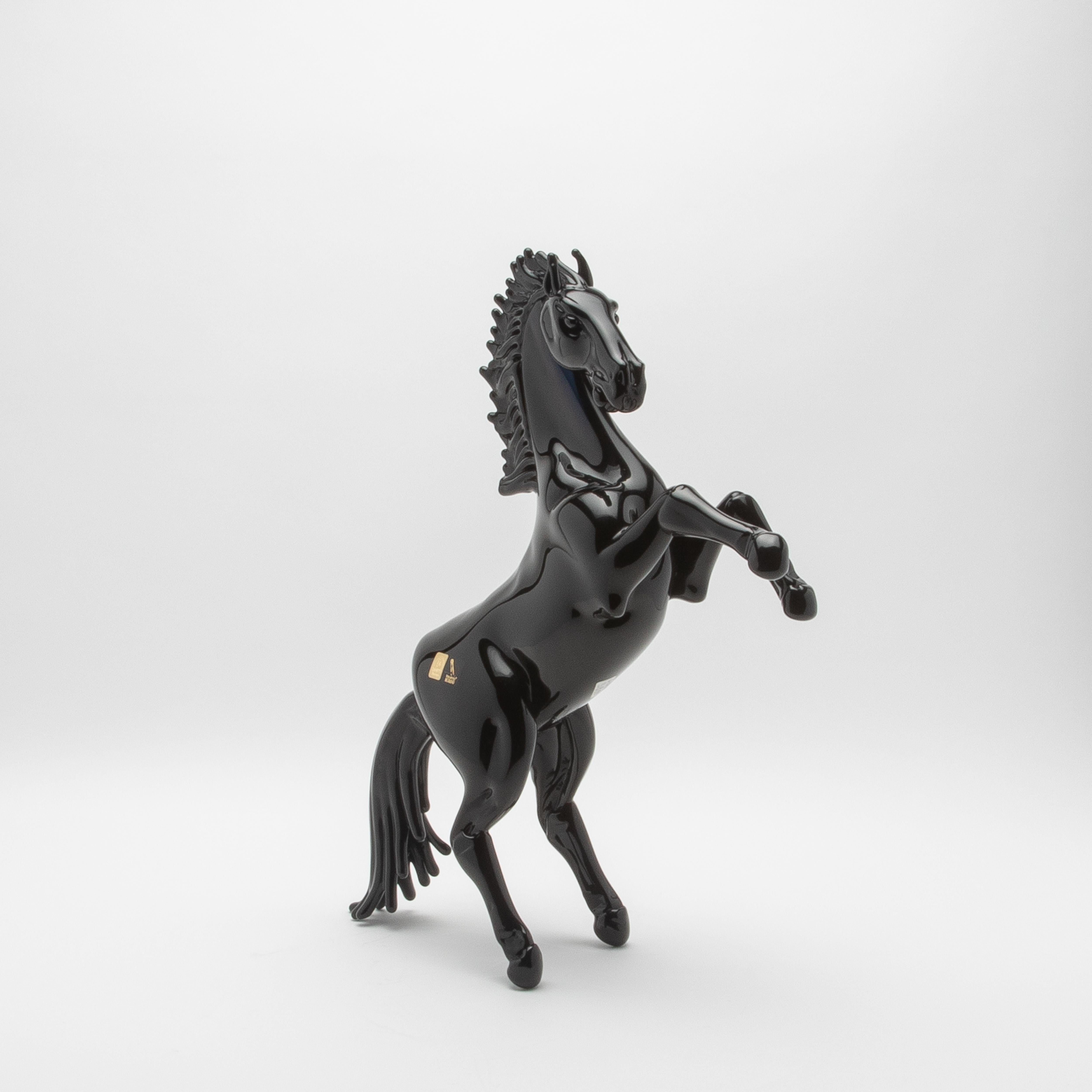 This hand-blown Murano glass horse sculpture, with its striking black finish, embodies the pinnacle of contemporary luxury and timeless artistry. Exquisitely sculpted by master artisans in Murano, Italy, the piece showcases their unparalleled skill