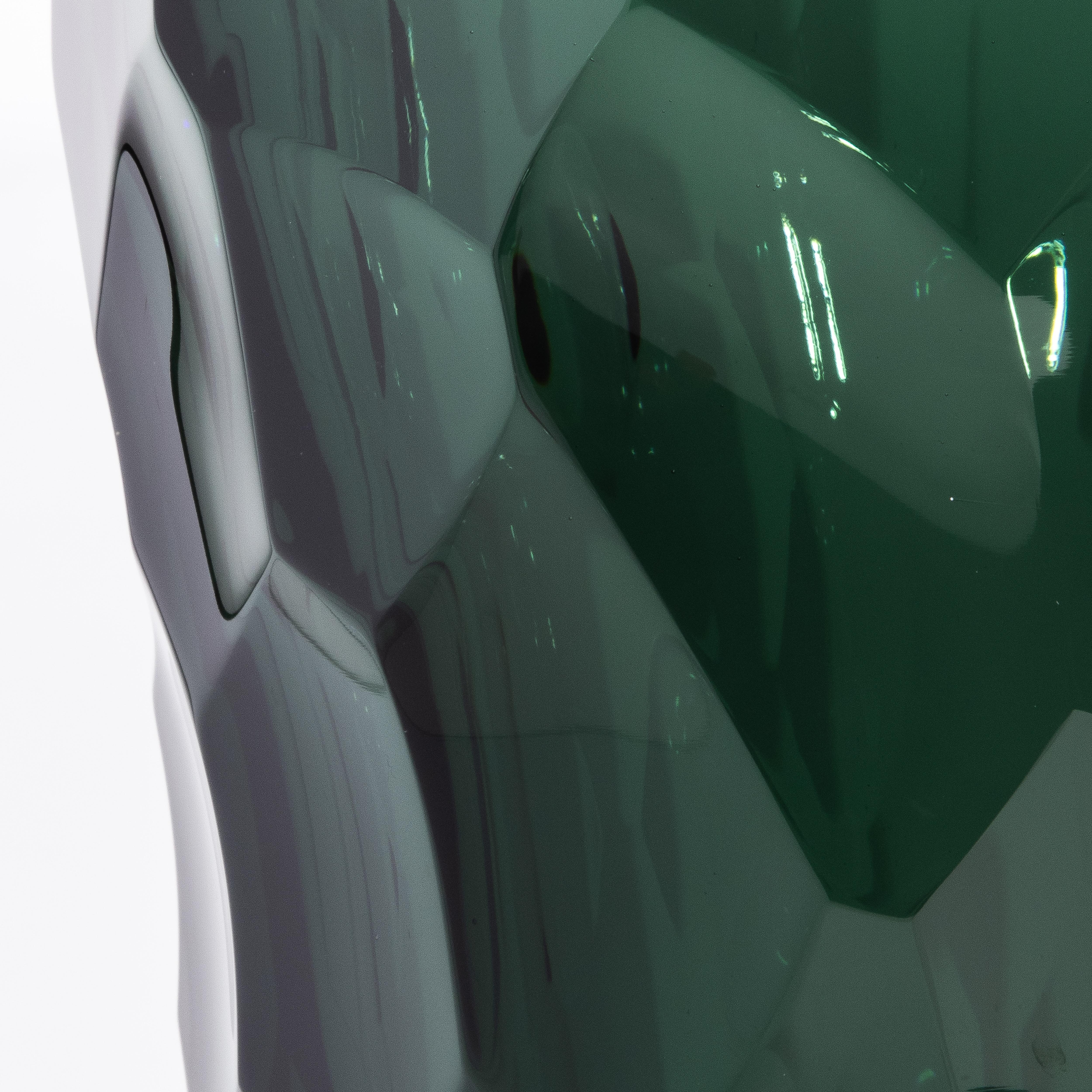 The Hand-Blown Murano Modern Tall Faceted Vase, known as the Luna Vase, an exquisite hand-blown Murano masterpiece, captivates with its faceted silhouette and deep eucalyptus green hue. Available in both a large 24” and a medium 19” version, its
