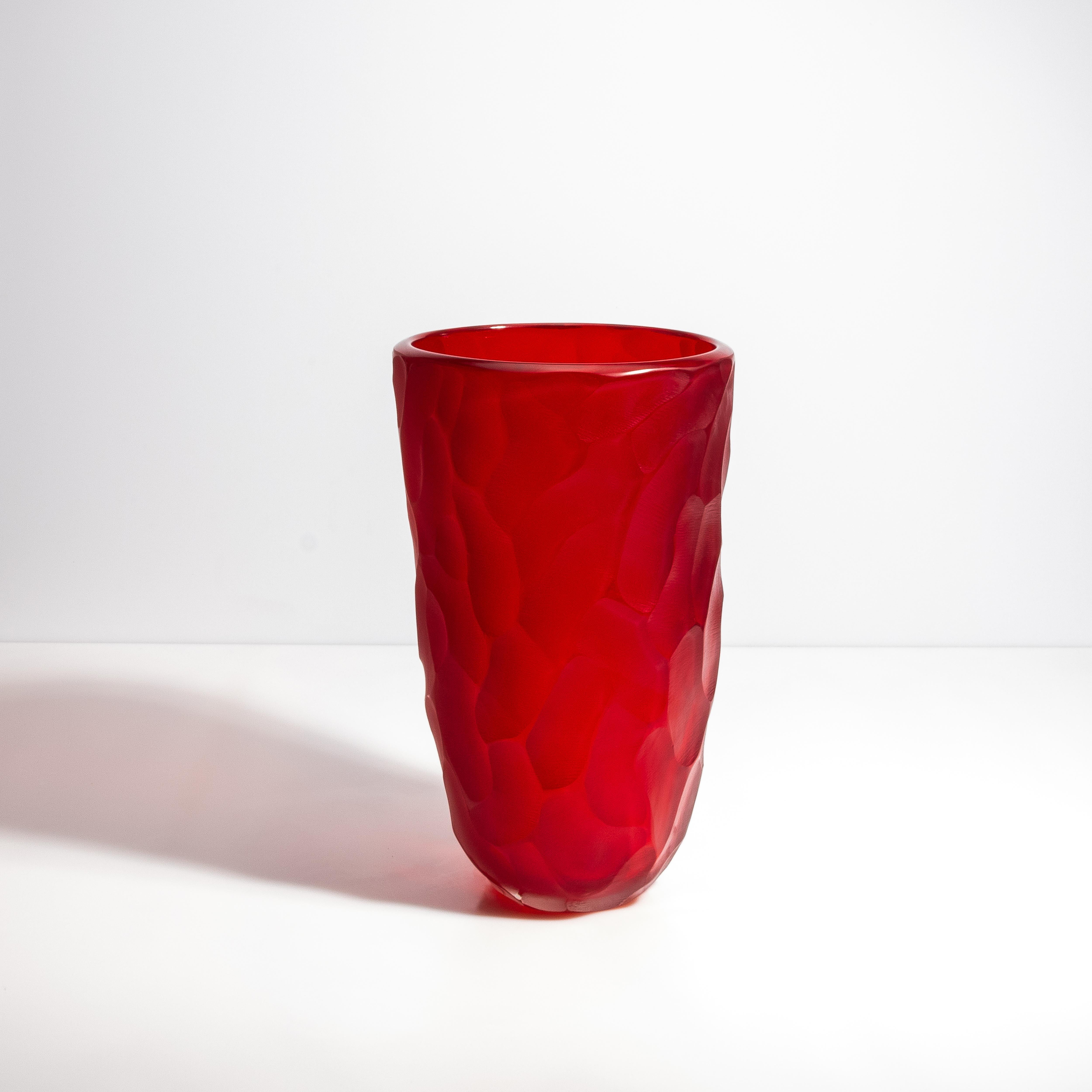 This exquisite vase features a luxurious matte red exterior with polished beveled edges creating a striking visual and tactile experience. The deep, rich red glaze is inspired by the lush hues of ruby, a stone symbolizing passion and vitality. It's