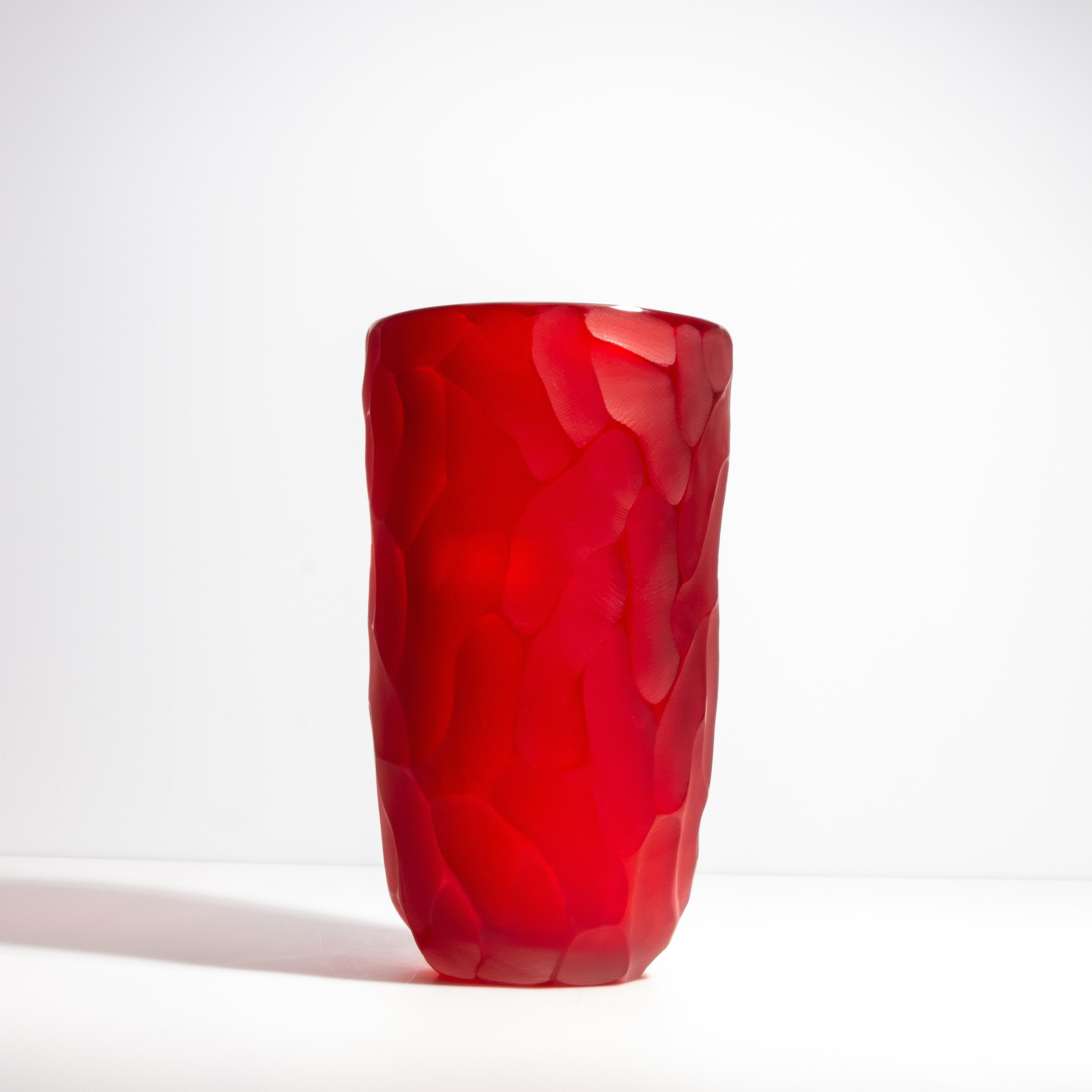 This exquisite vase features a luxurious matte red exterior with polished beveled edges creating a striking visual and tactile experience. The deep, rich red glaze is inspired by the lush hues of ruby, a stone symbolizing passion and vitality. It's