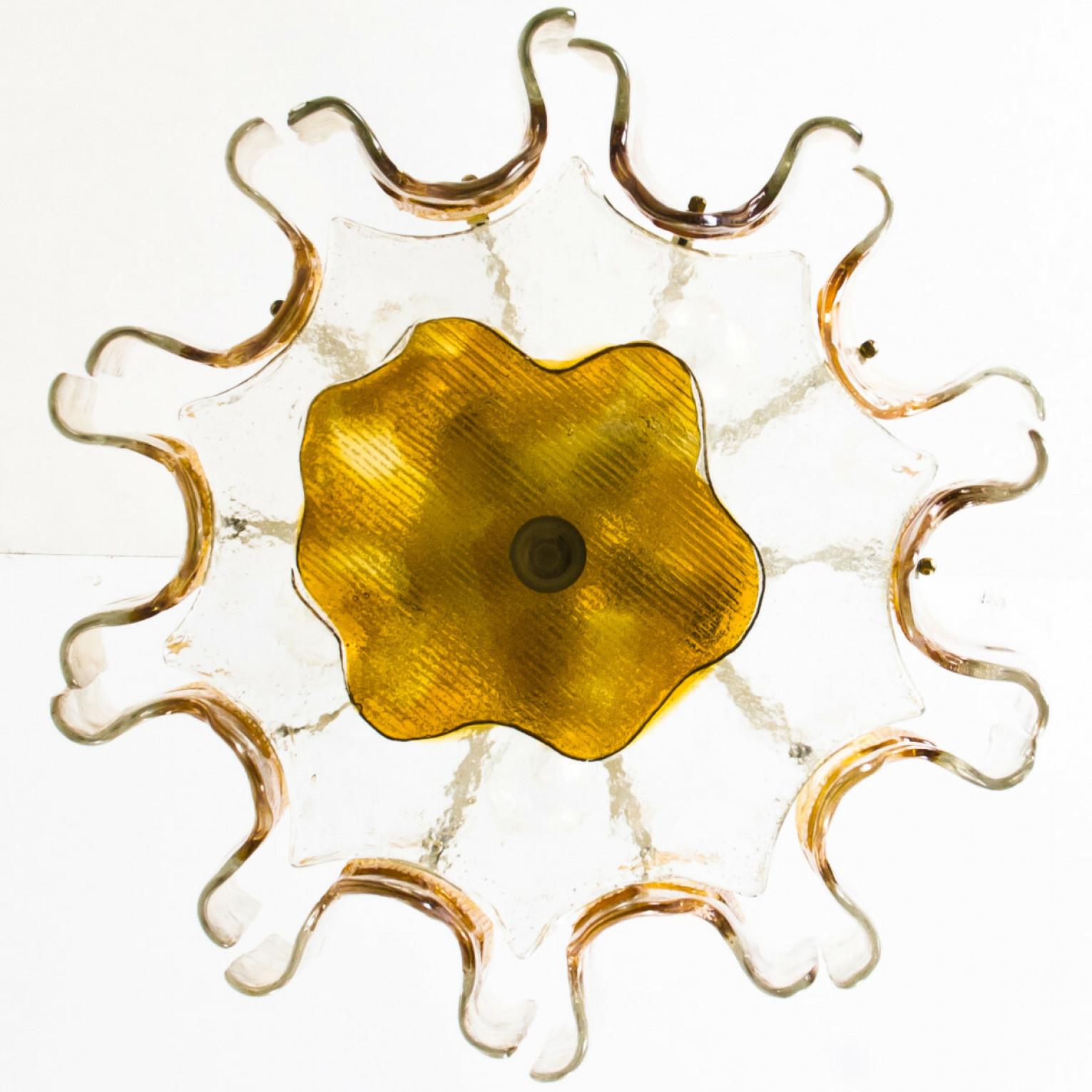 A beautiful light fixture in the style of Mazzega, manufactured in the mid century, circa 1970 (end of 1960s and beginning of 1970s). a bi-colored (clear and orange) hand blown glass. Each piece of glass meticulously hand formed in clear glass with